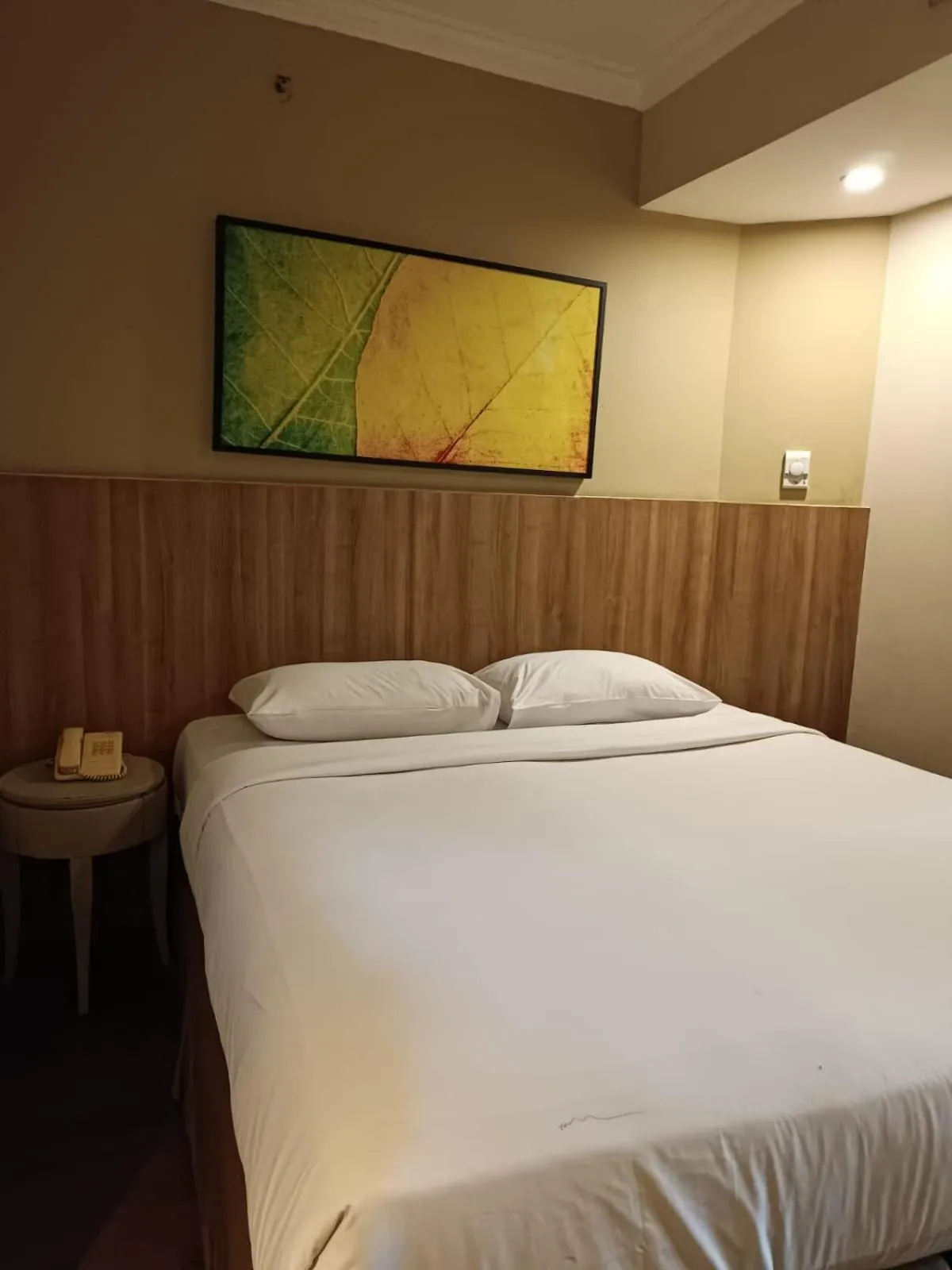 Bed in Grand Tropic Suites Hotel