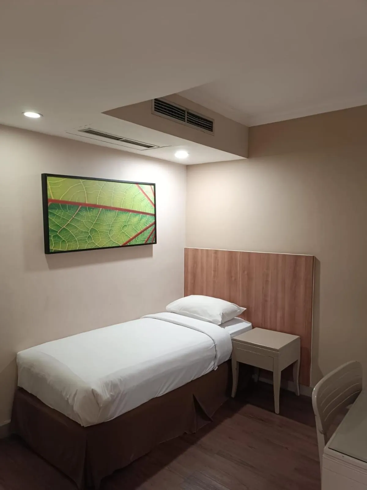 Bed in Grand Tropic Suites Hotel