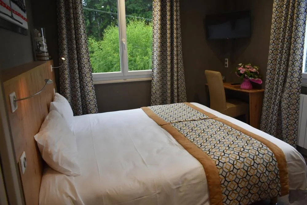 Bed in Logis Hôtel Beau Site
