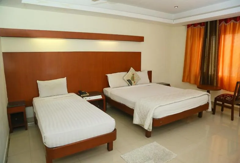 Photo of the whole room, Bed in Dhanunjayas Luxury Hotel