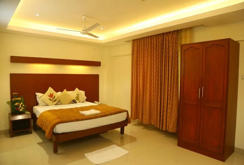 Photo of the whole room, Bed in Dhanunjayas Luxury Hotel