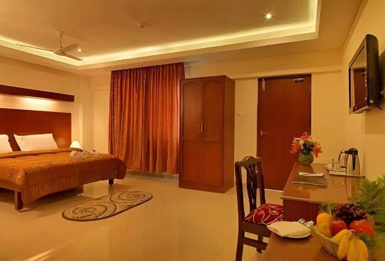 Photo of the whole room, Bed in Dhanunjayas Luxury Hotel