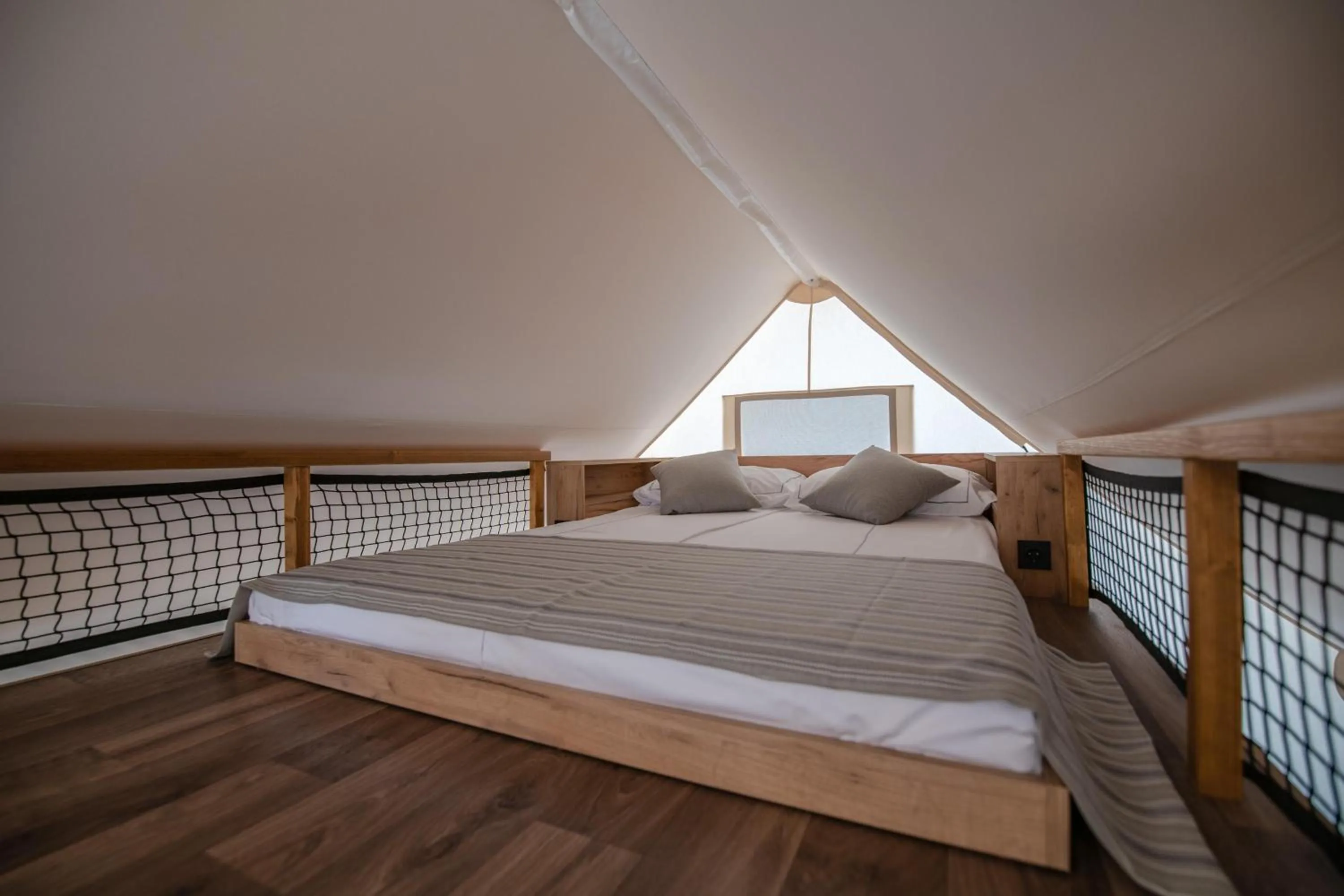 Bed in Arena One 99 Glamping