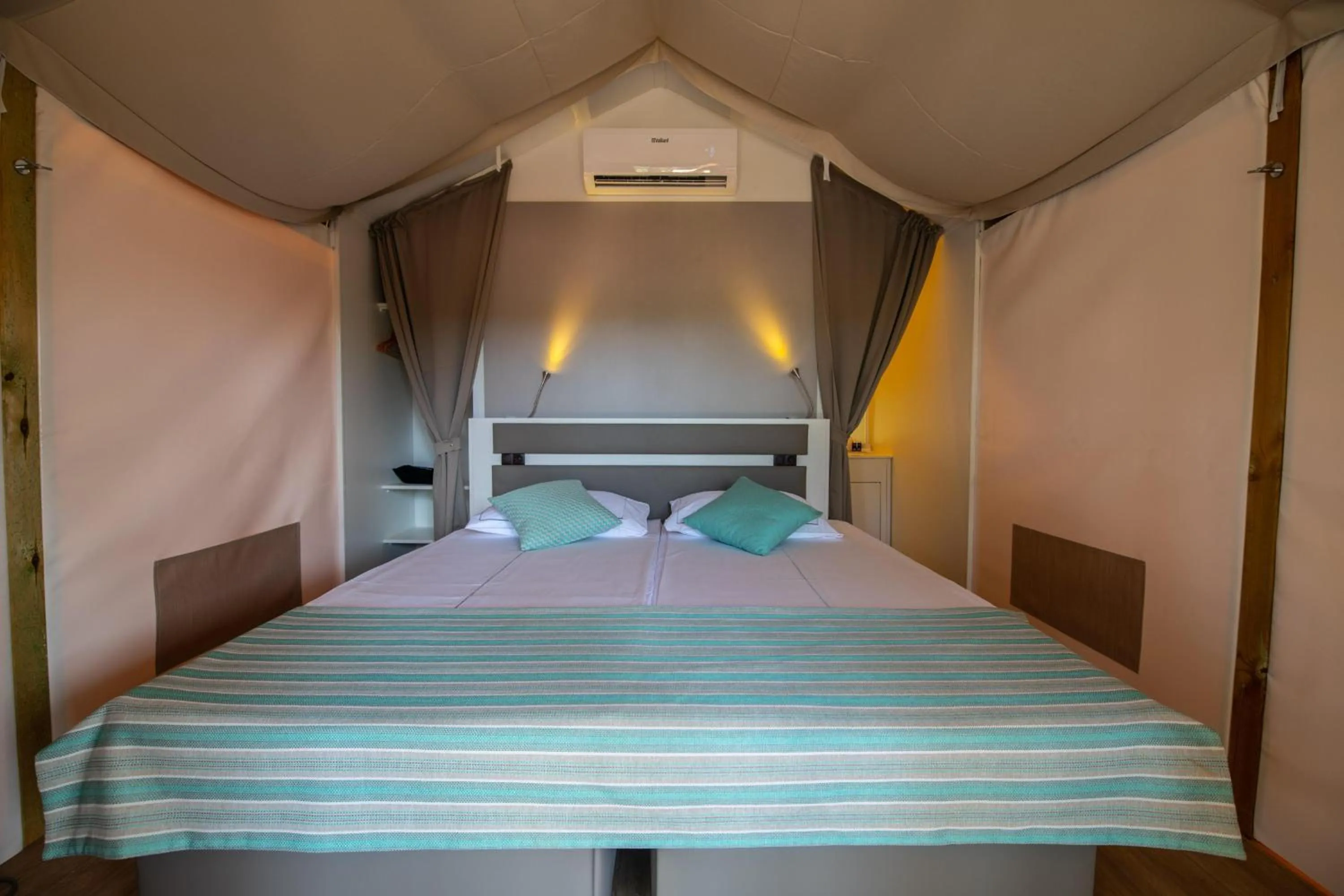 Bed in Arena One 99 Glamping