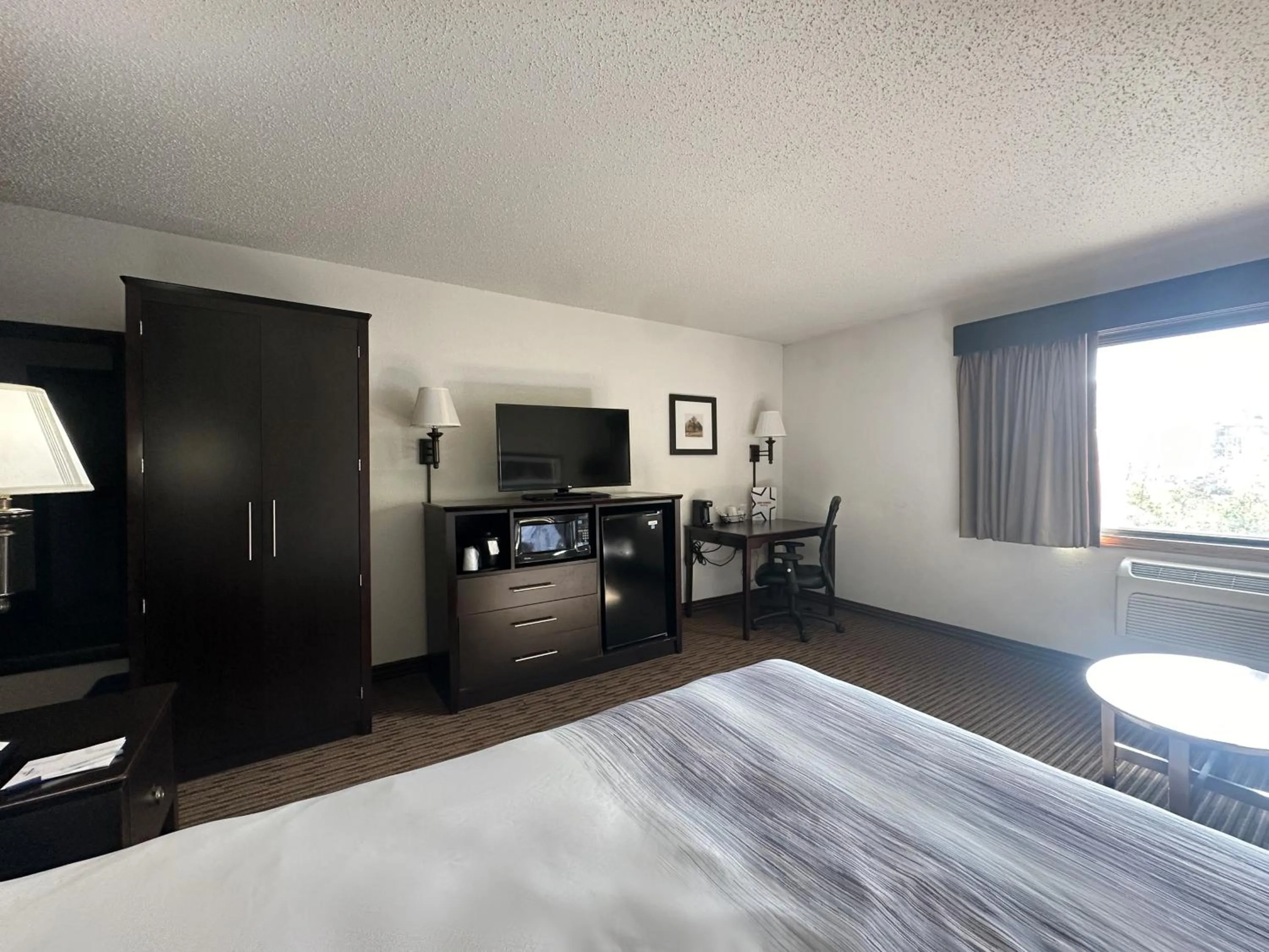 Bed in AmericInn by Wyndham Menominee