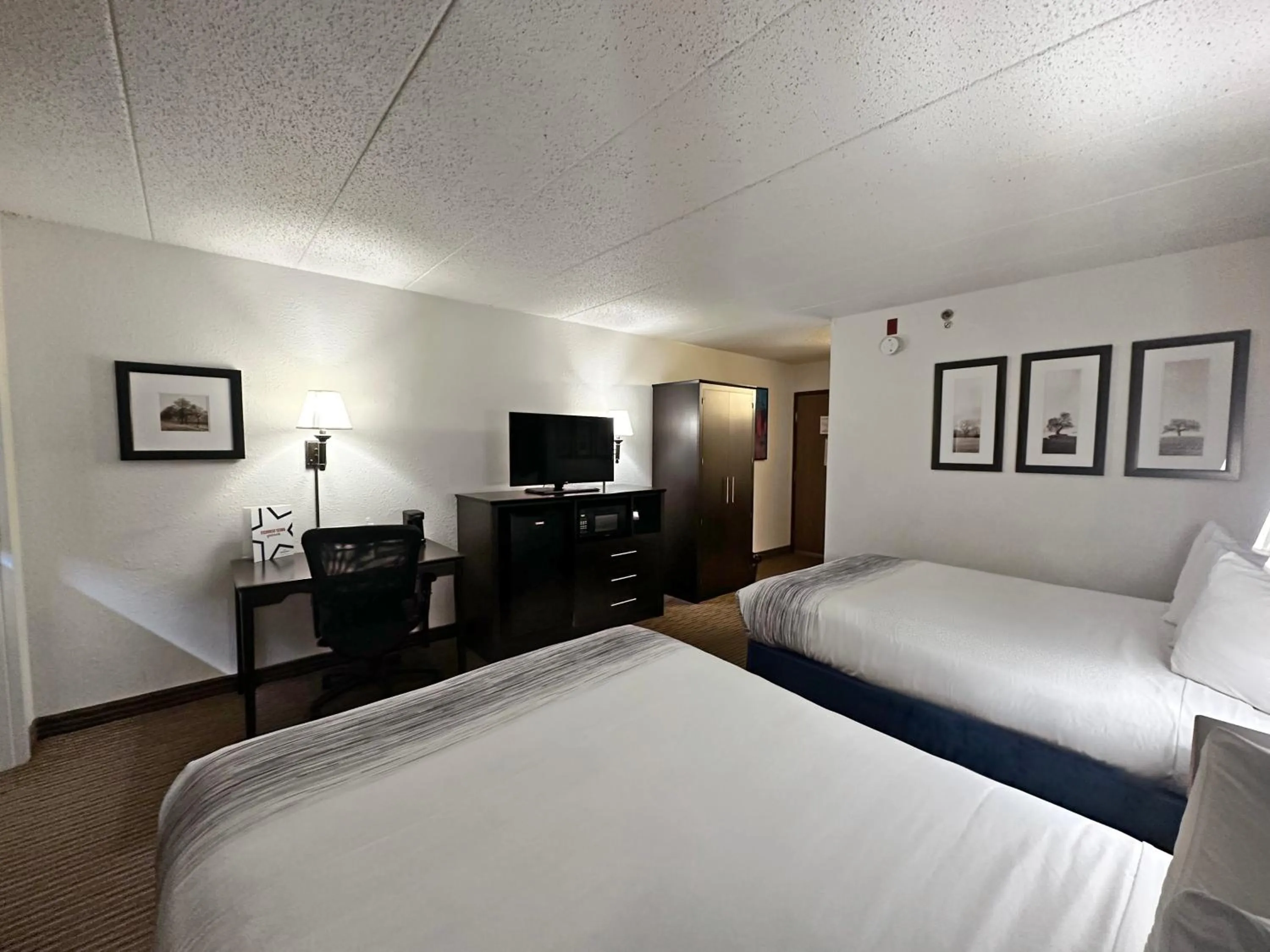 Bed in AmericInn by Wyndham Menominee
