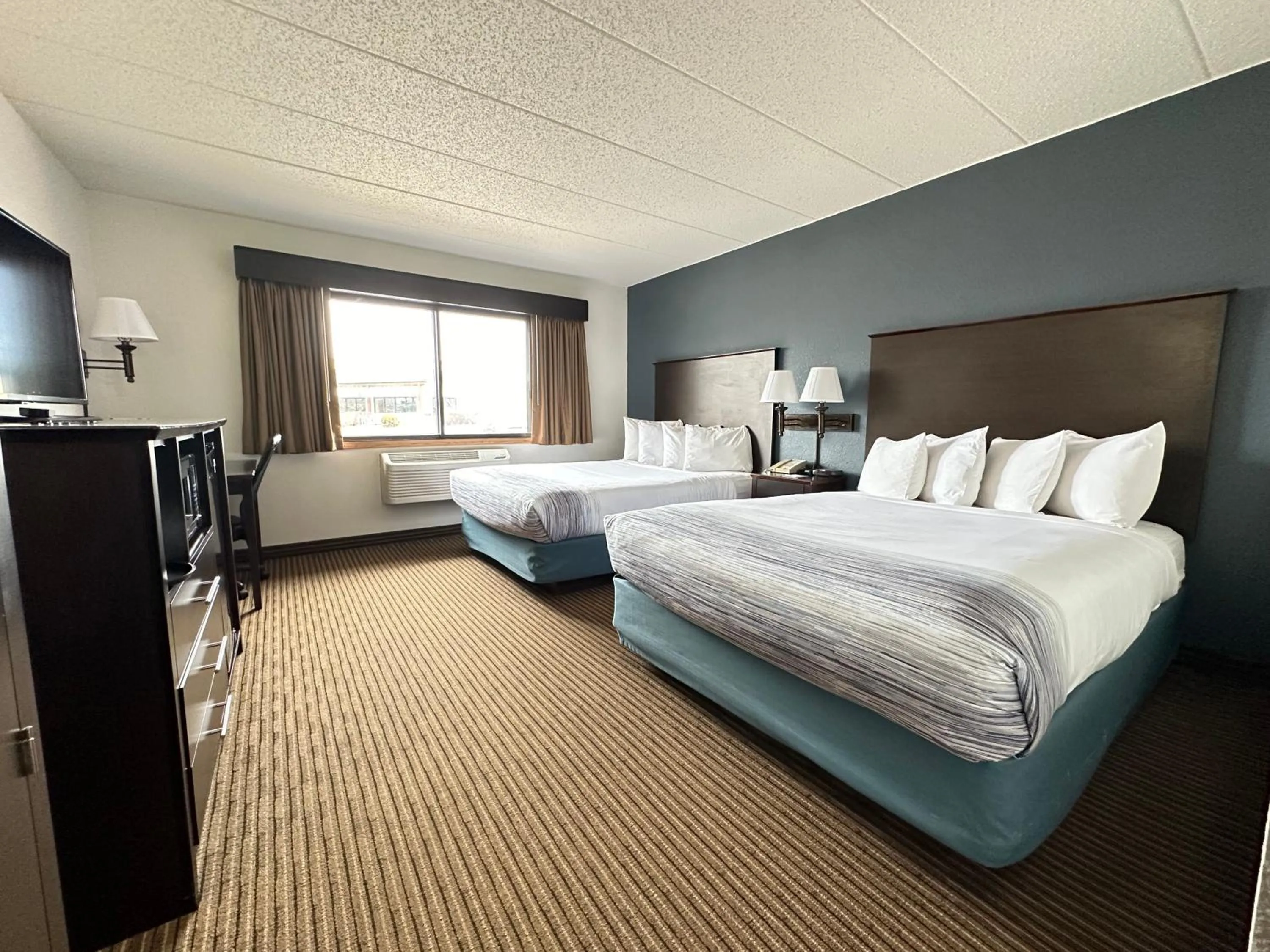 Bed in AmericInn by Wyndham Menominee