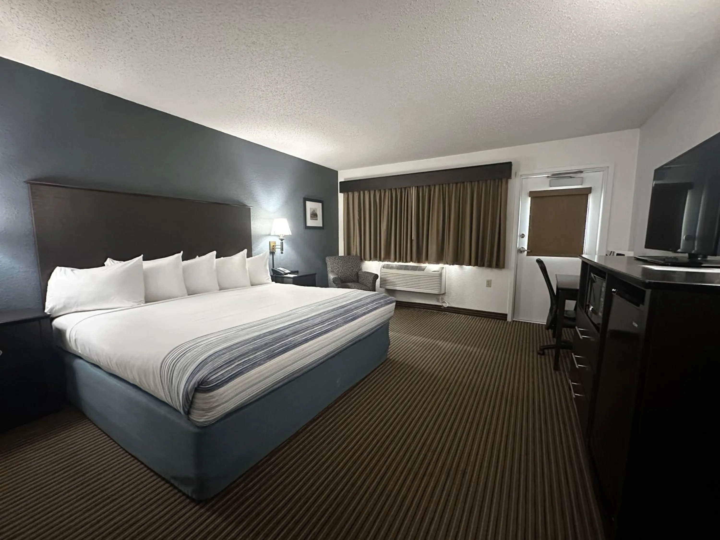 Bed in AmericInn by Wyndham Menominee