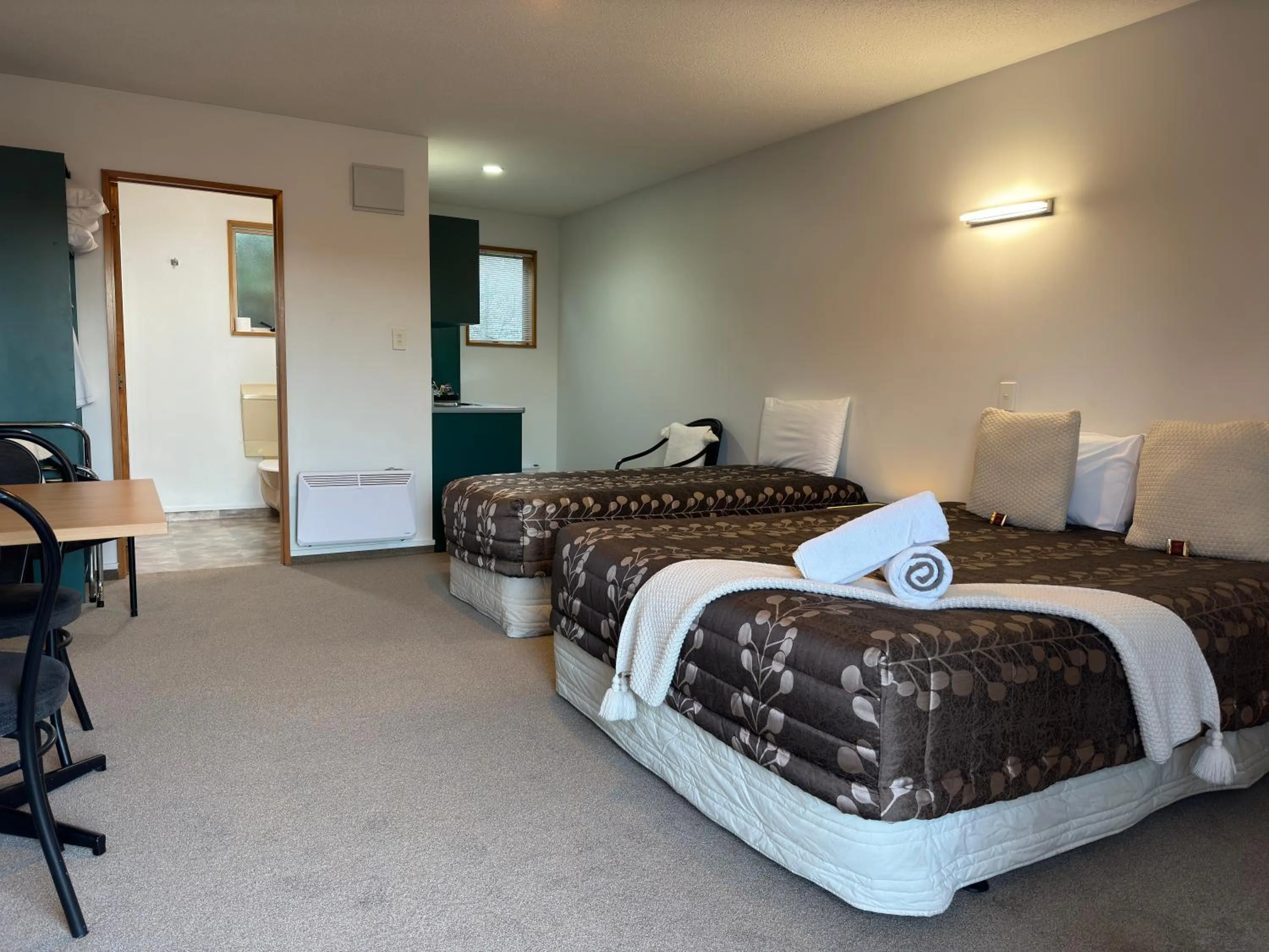 Bed in ASURE Ambassador Motor Lodge