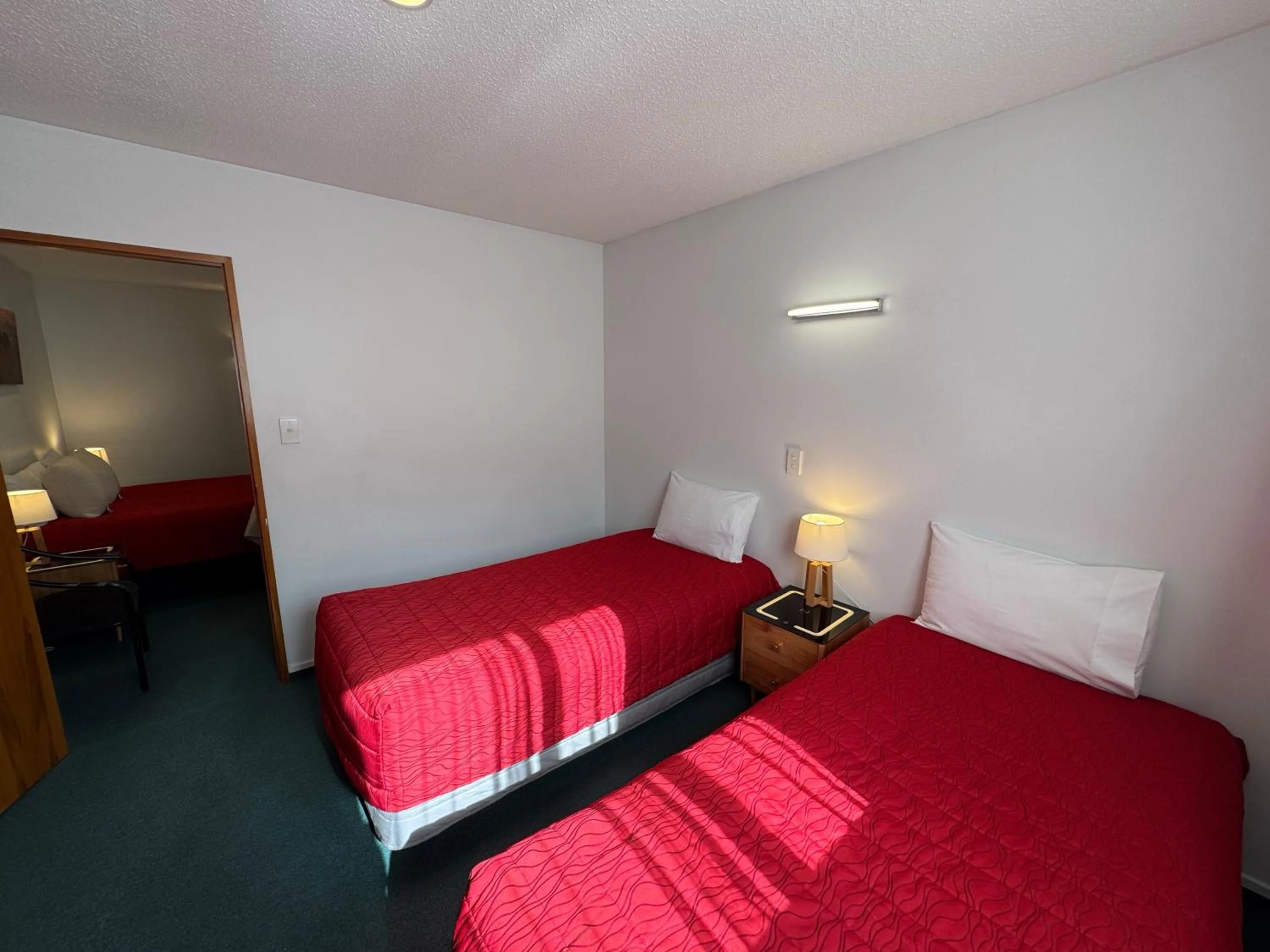 Bed in ASURE Ambassador Motor Lodge