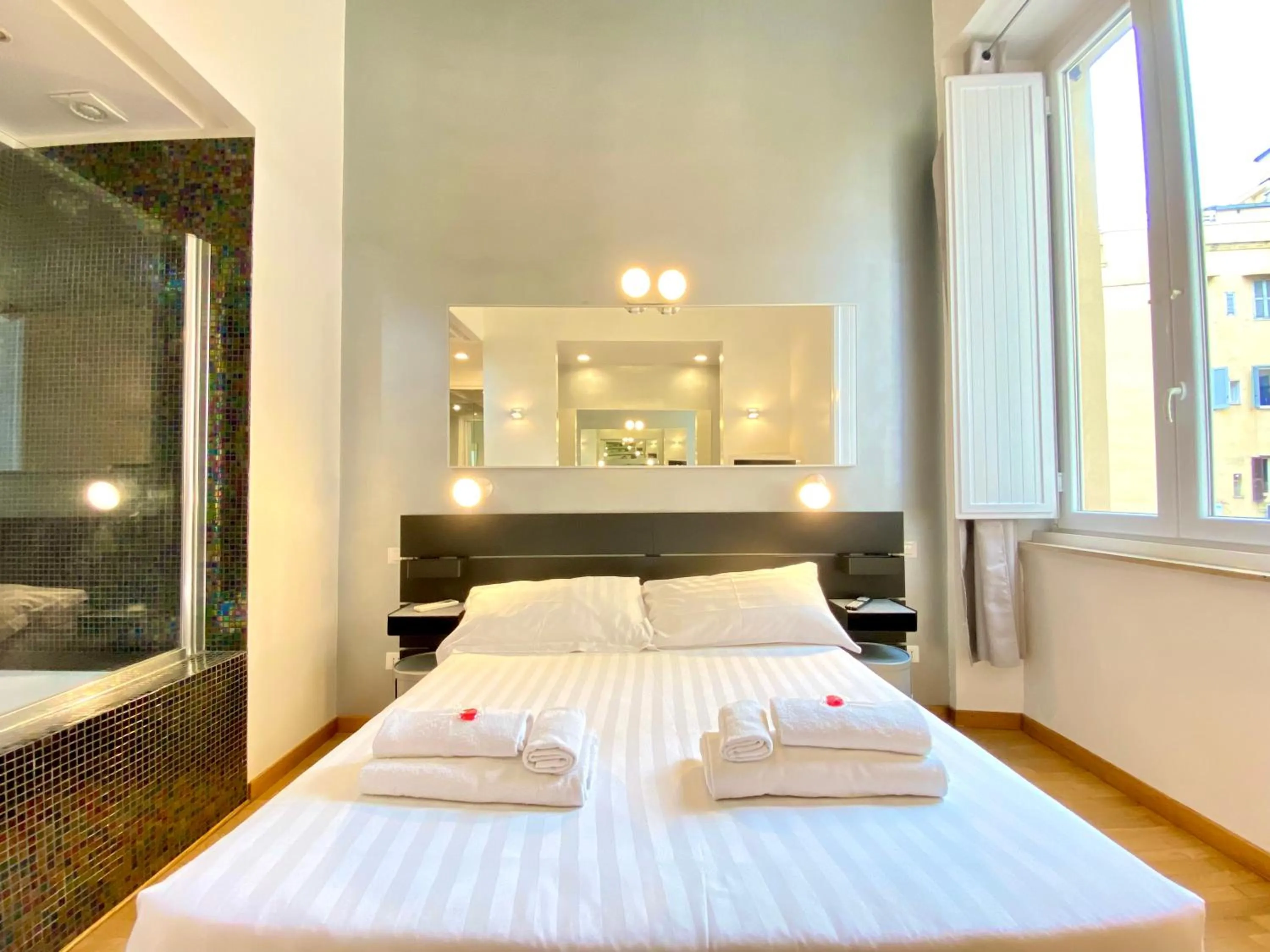 Bed in KISS ME ROME Luxury Rooms