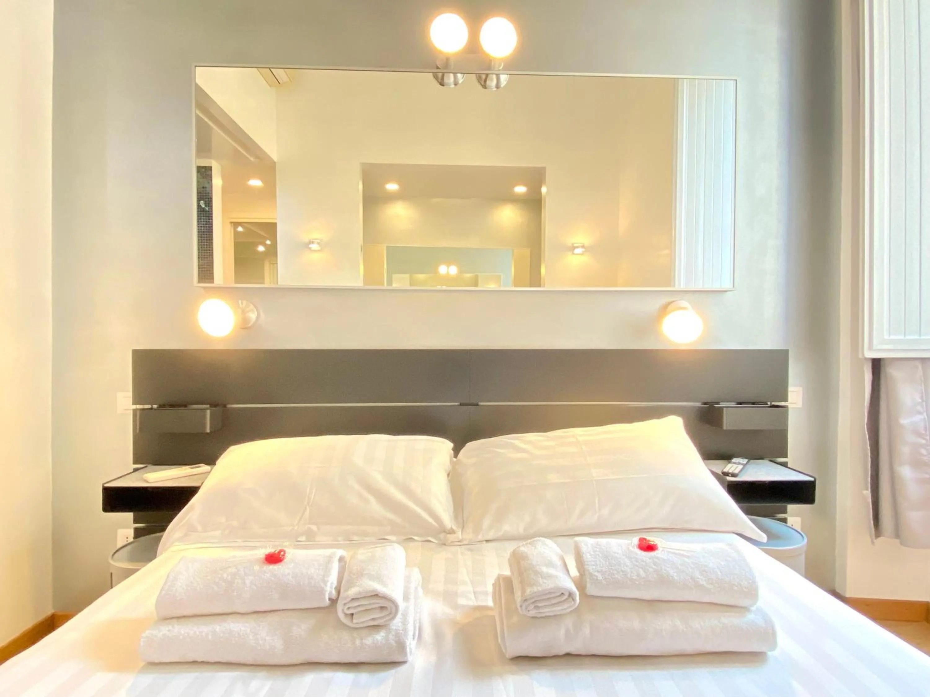 Bed in KISS ME ROME Luxury Rooms