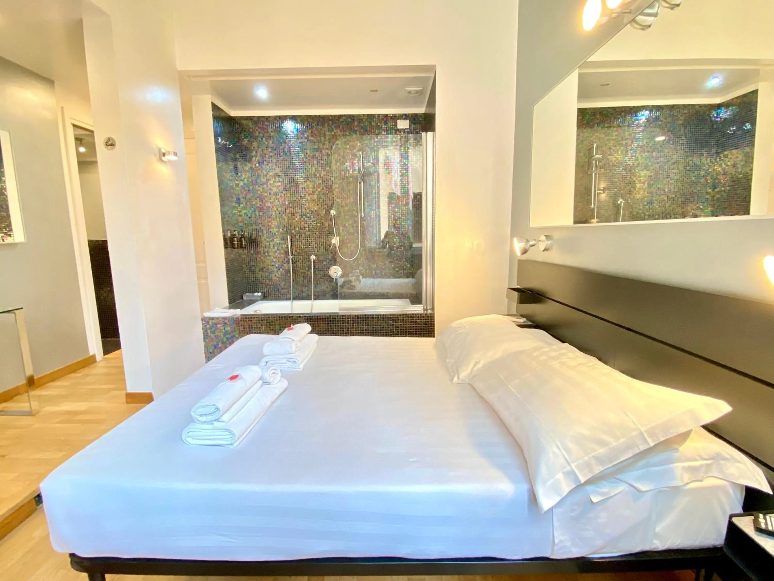 Bed in KISS ME ROME Luxury Rooms