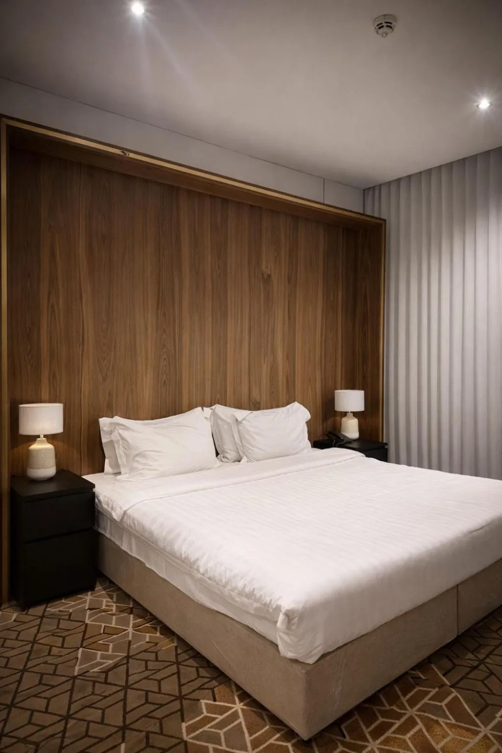 Bed in LeChateau Boutique Hotel