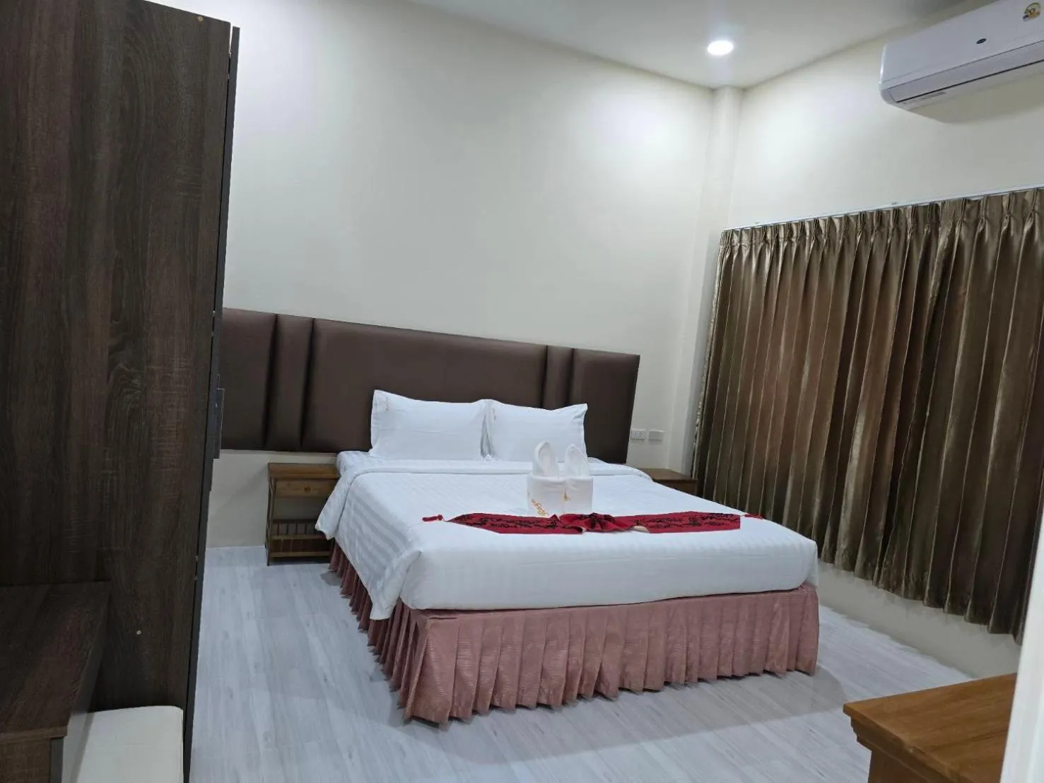 Bed in Natural Samui Hotel