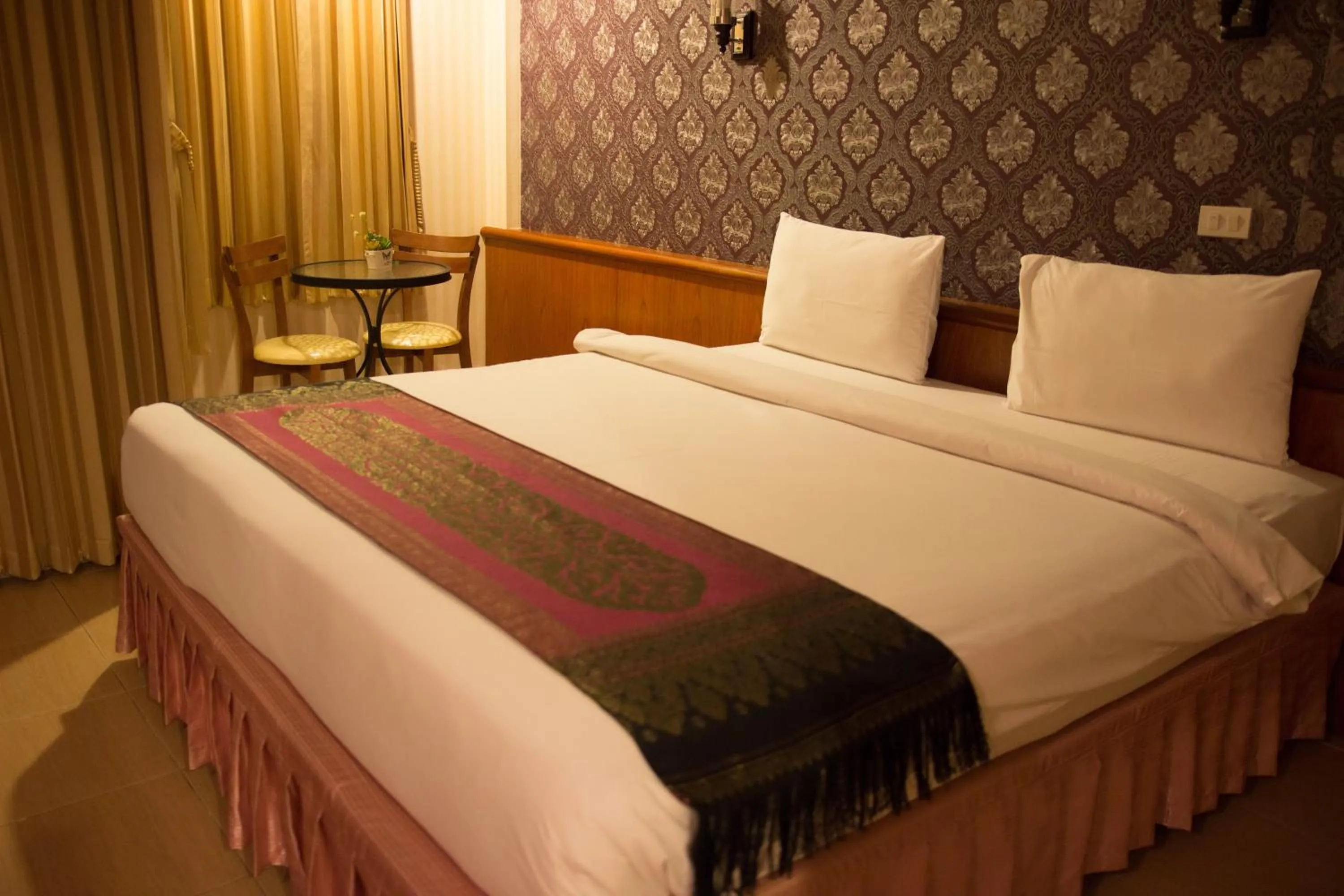 Bed in Natural Samui Hotel