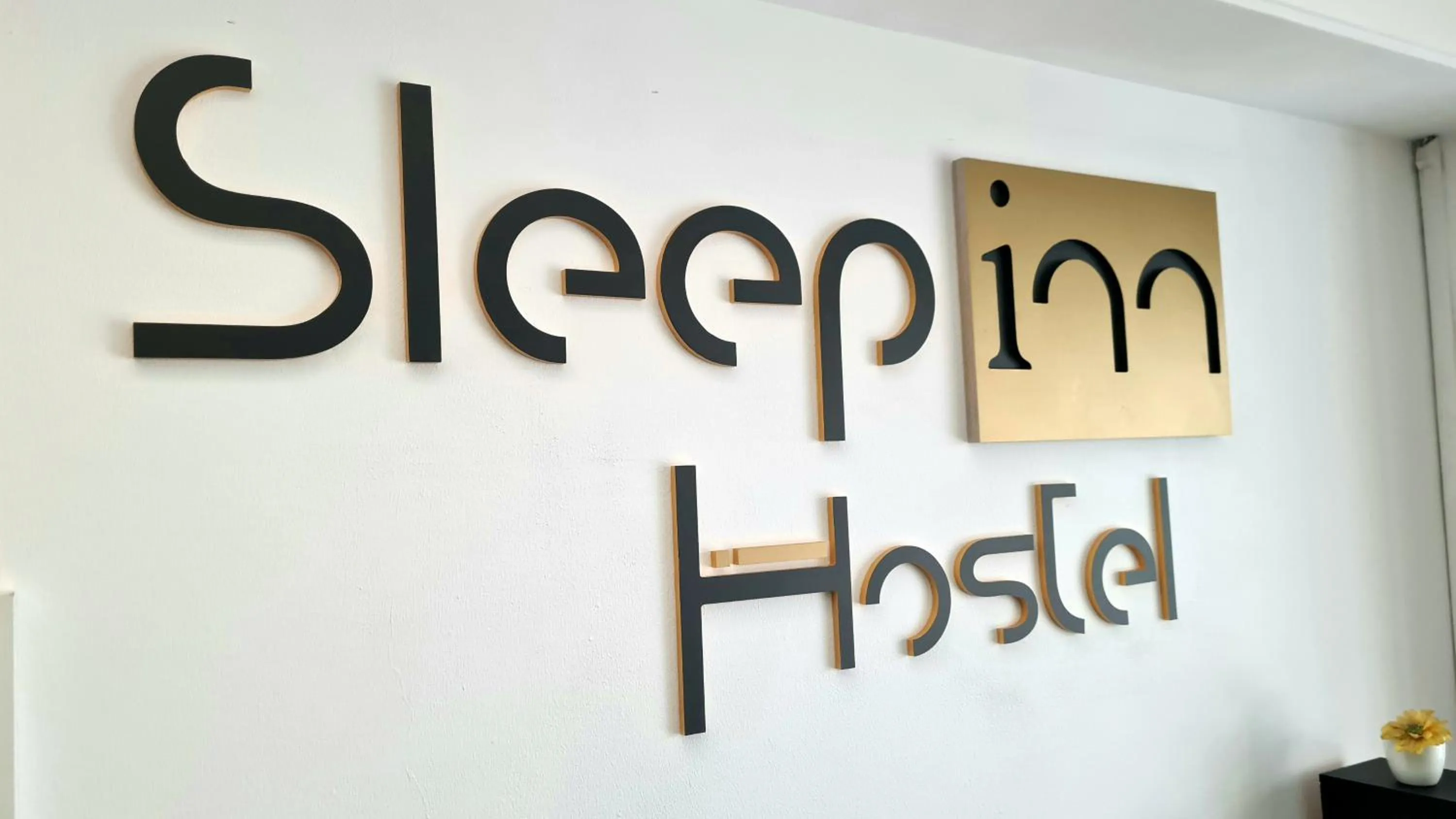 Property logo or sign in Sleep Inn Hostel