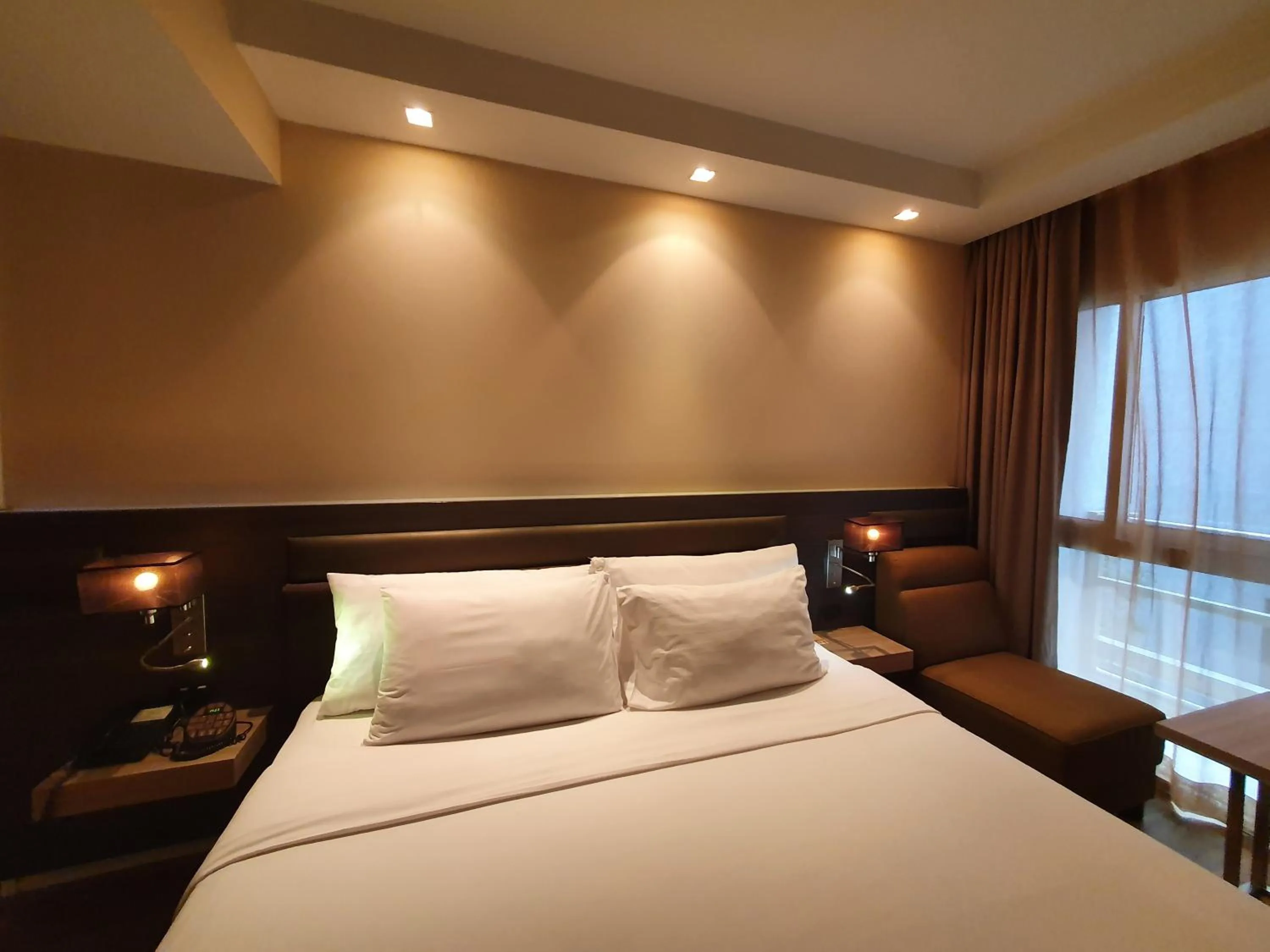 Bed in Amora NeoLuxe Suites Hotel