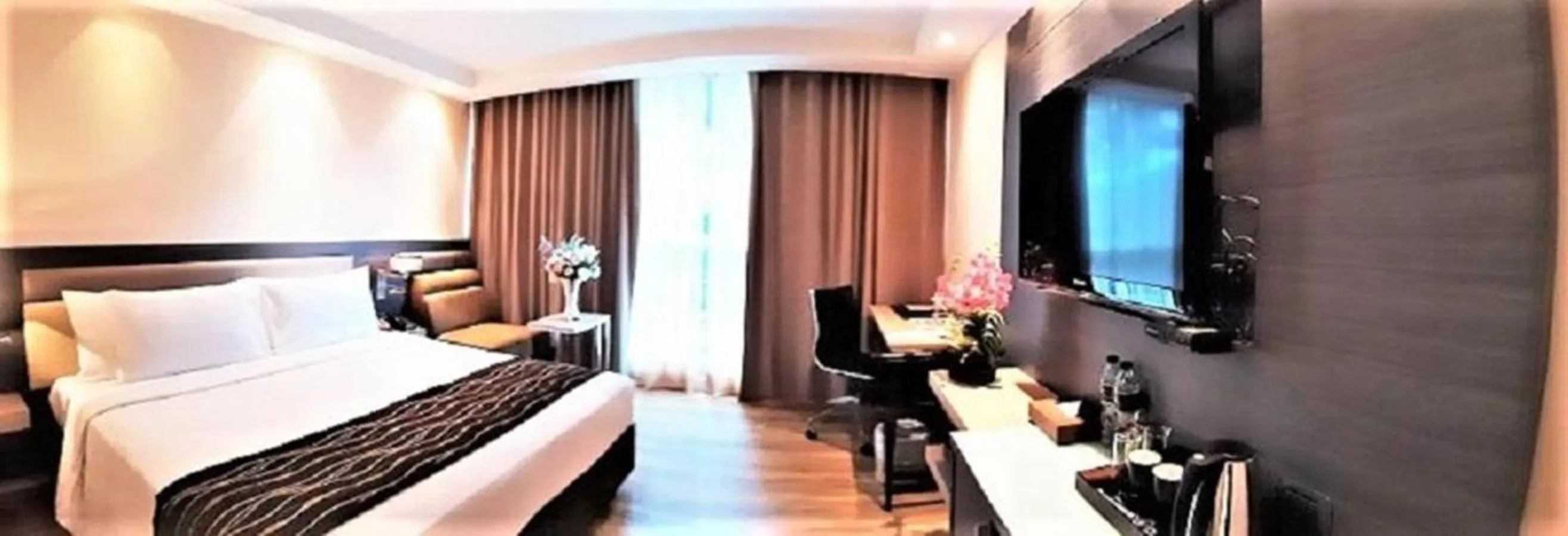 Bed in Amora NeoLuxe Suites Hotel