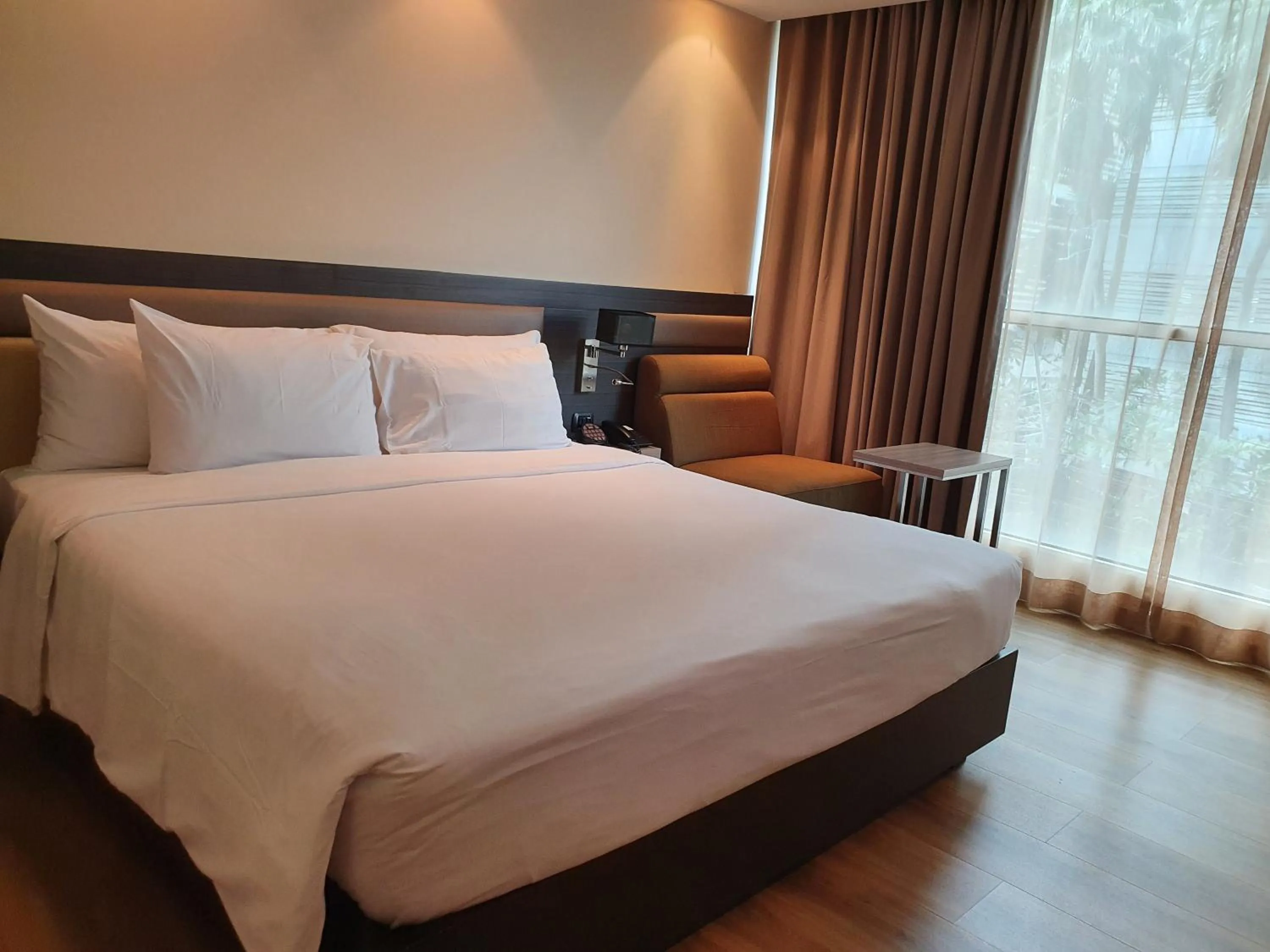 Bed in Amora NeoLuxe Suites Hotel