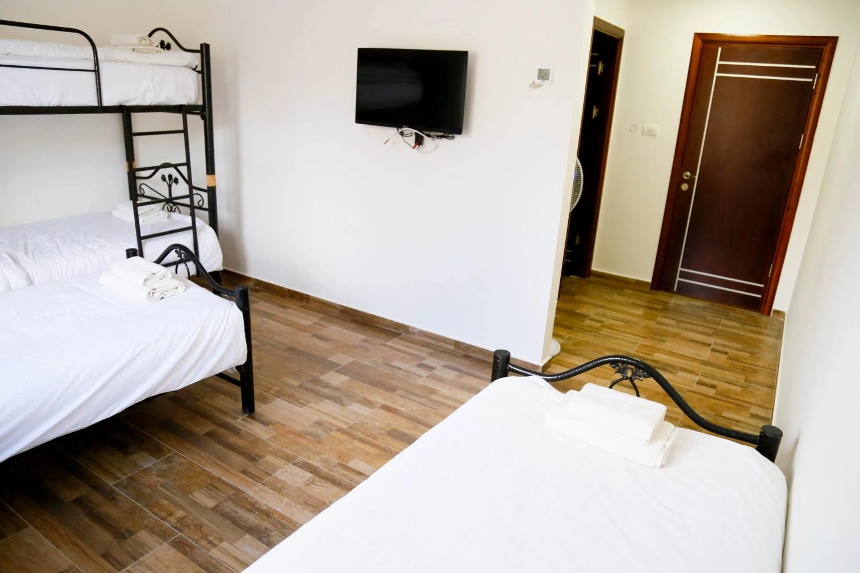 Communal lounge/ TV room, Bed in Alrowwad Guest House