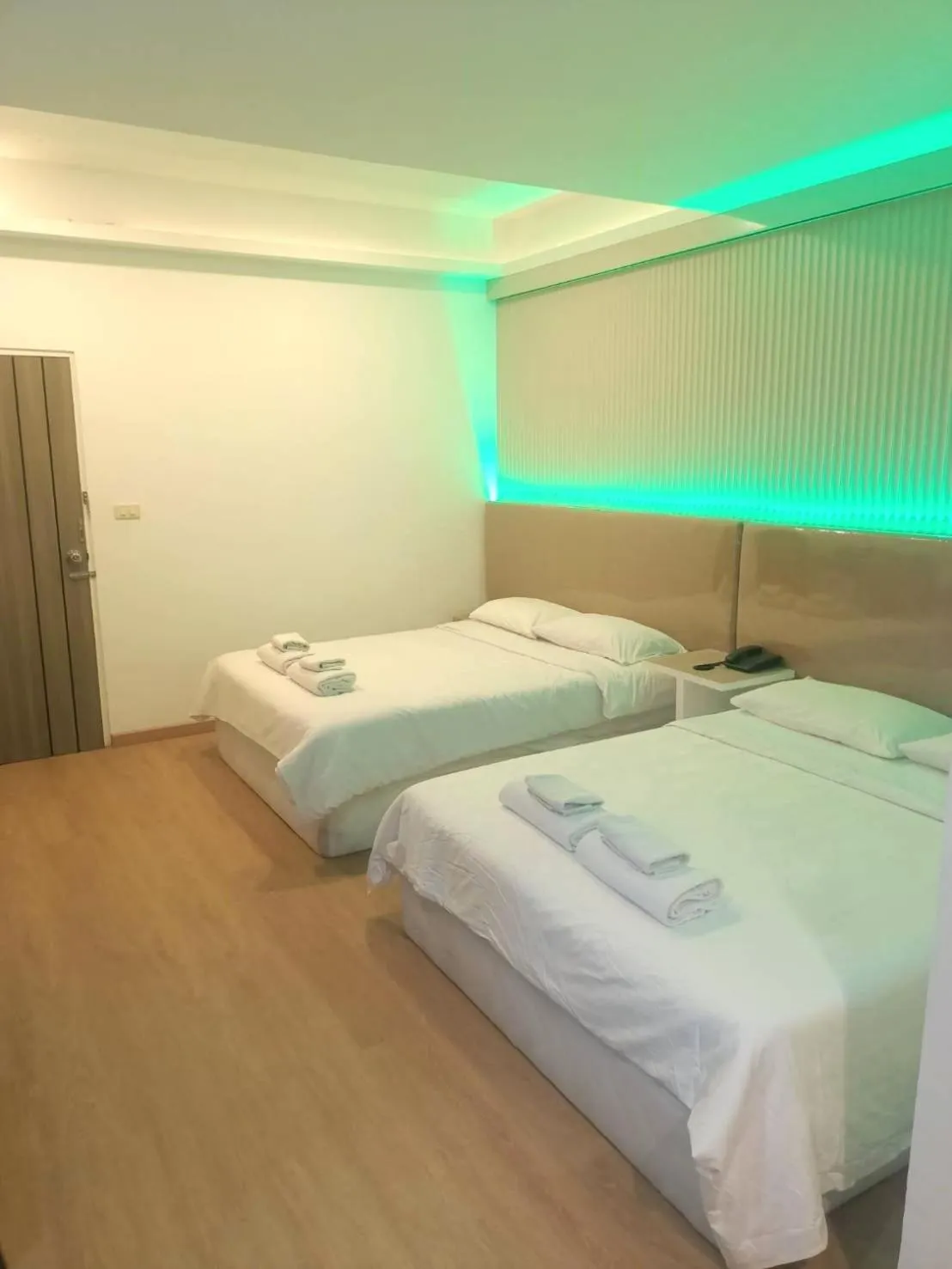 Bed in Royal Garden Home Hotel