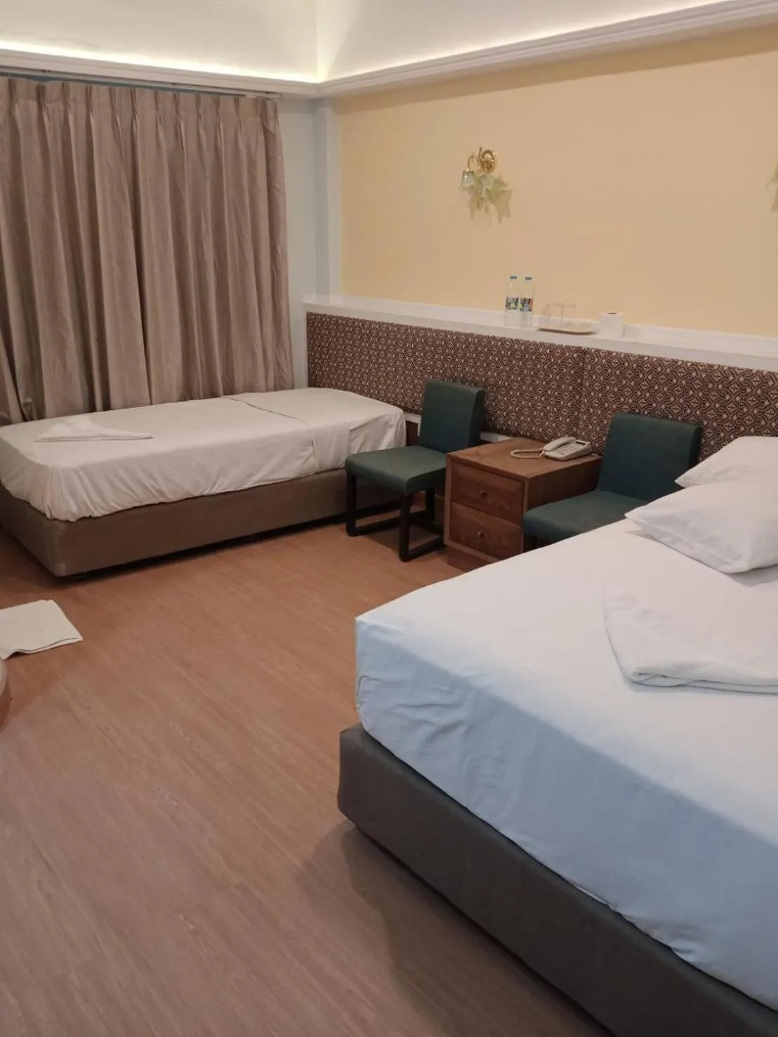 Bed in Royal Garden Home Hotel