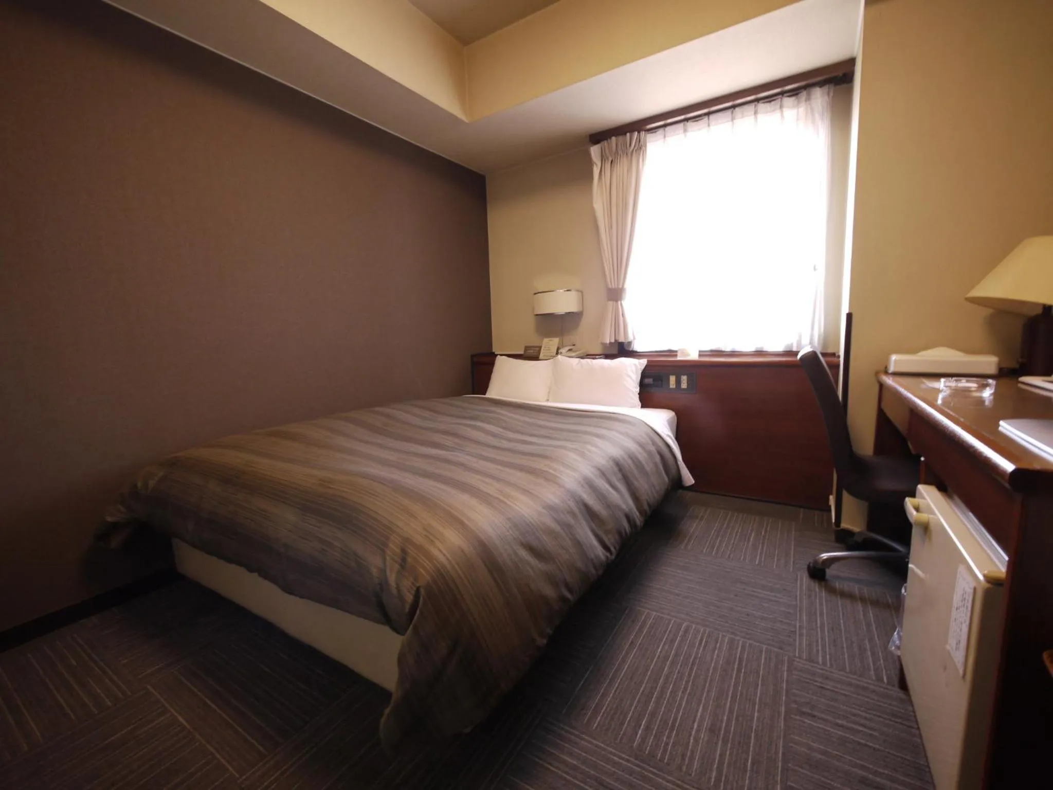 Photo of the whole room, Bed in Hotel Route-Inn Dai-ichi Nagano