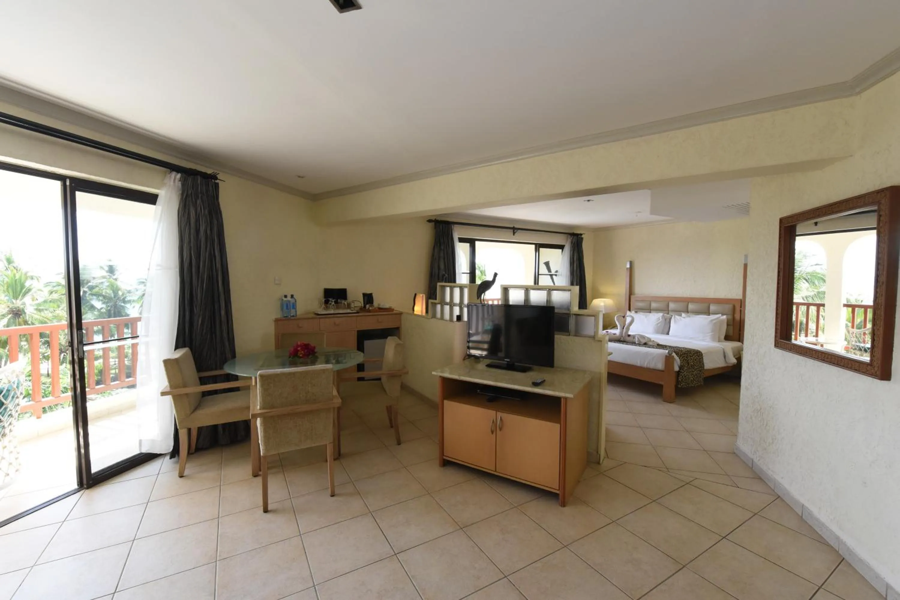 Living room, Bed in Diani Reef Beach Resort & Spa - Your Beachfront Bliss Awaits