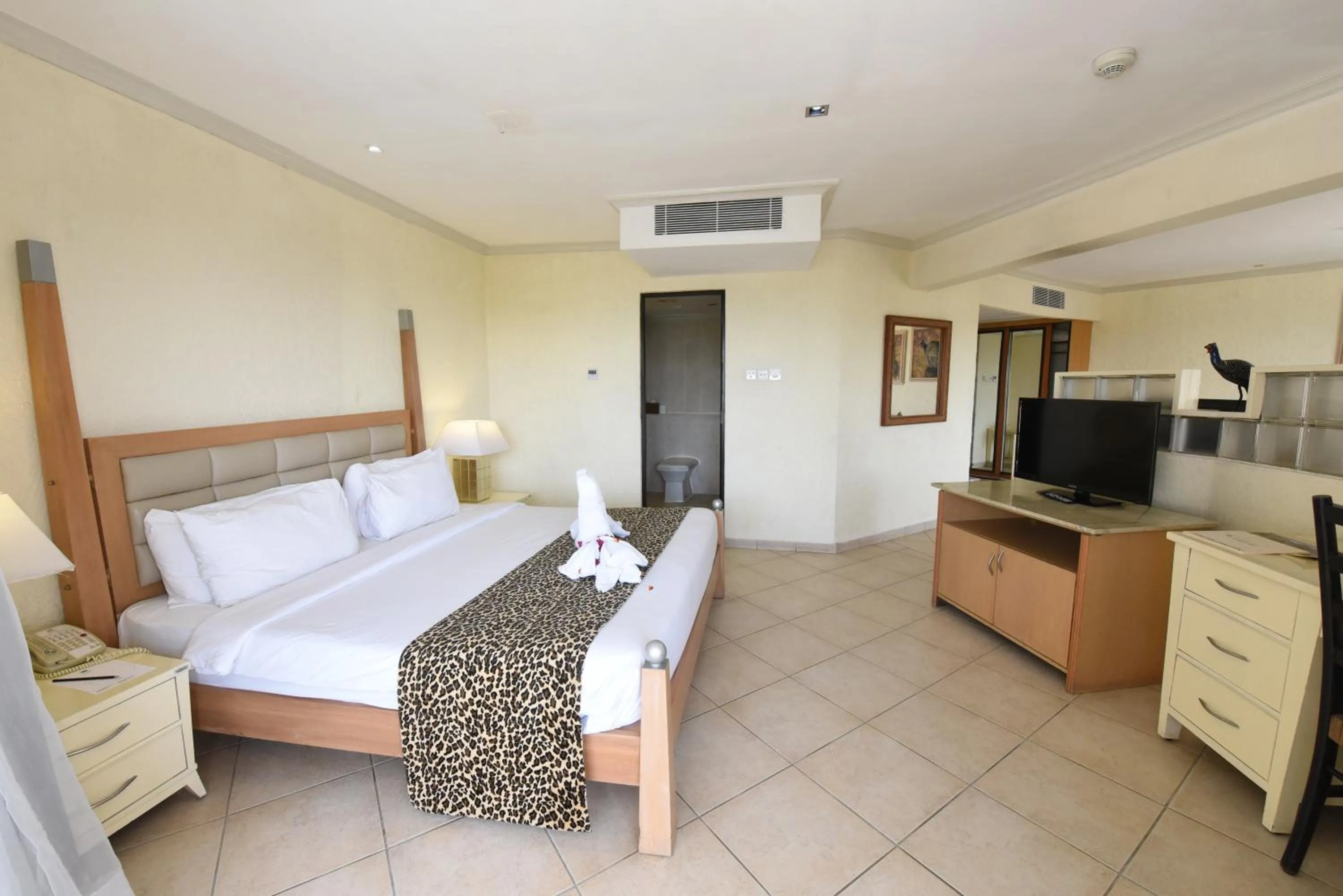 Communal lounge/ TV room, Bed in Diani Reef Beach Resort & Spa - Your Beachfront Bliss Awaits
