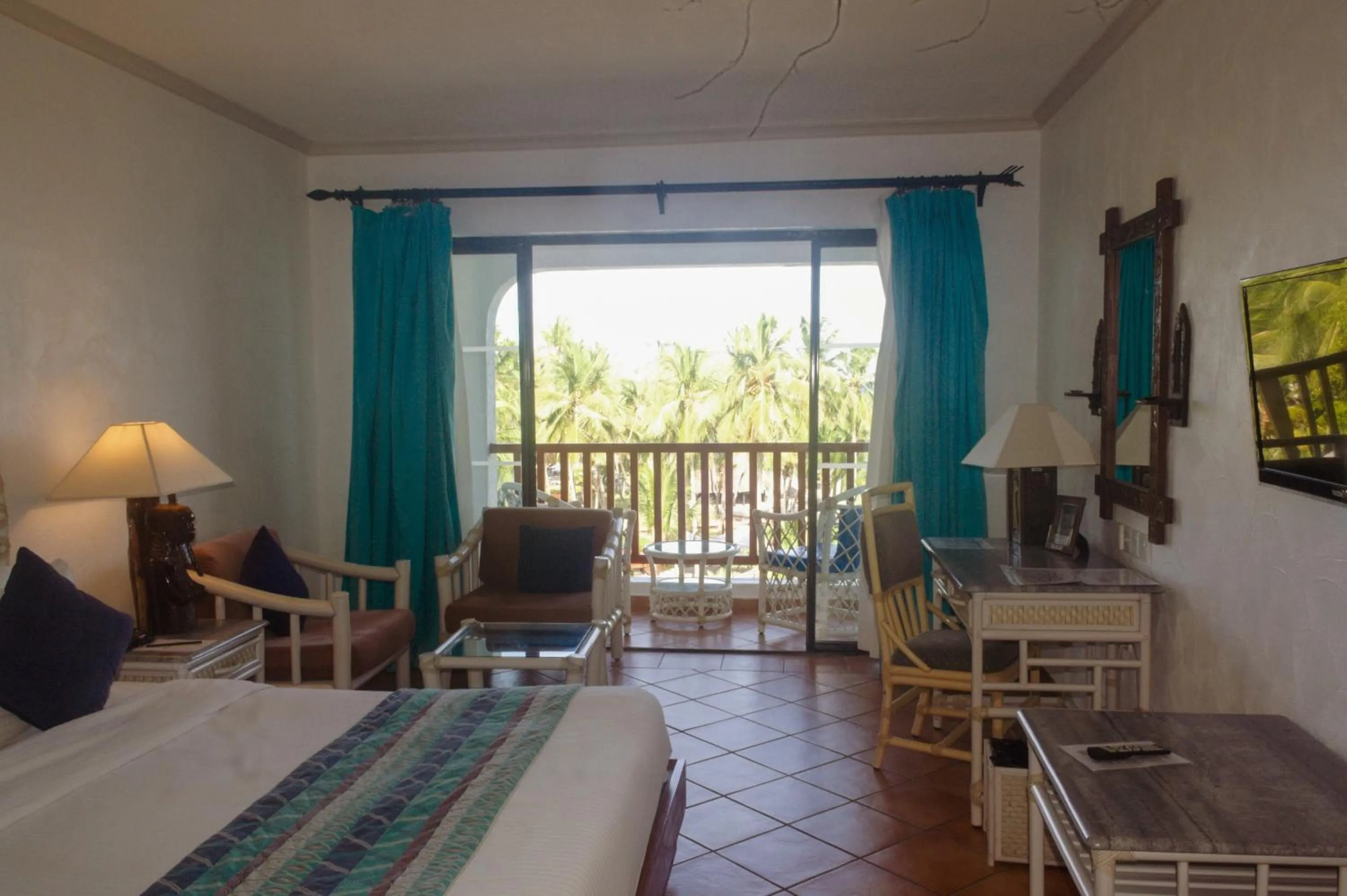 Photo of the whole room, Bed in Diani Reef Beach Resort & Spa - Your Beachfront Bliss Awaits