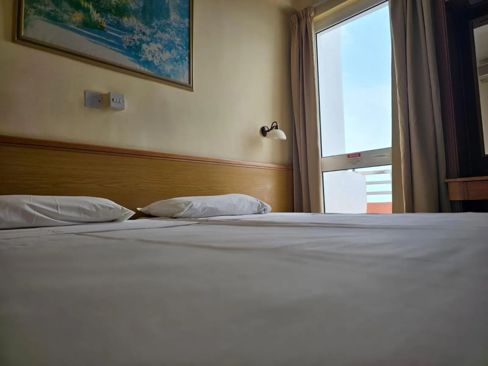 Bed in Ambassador Hotel