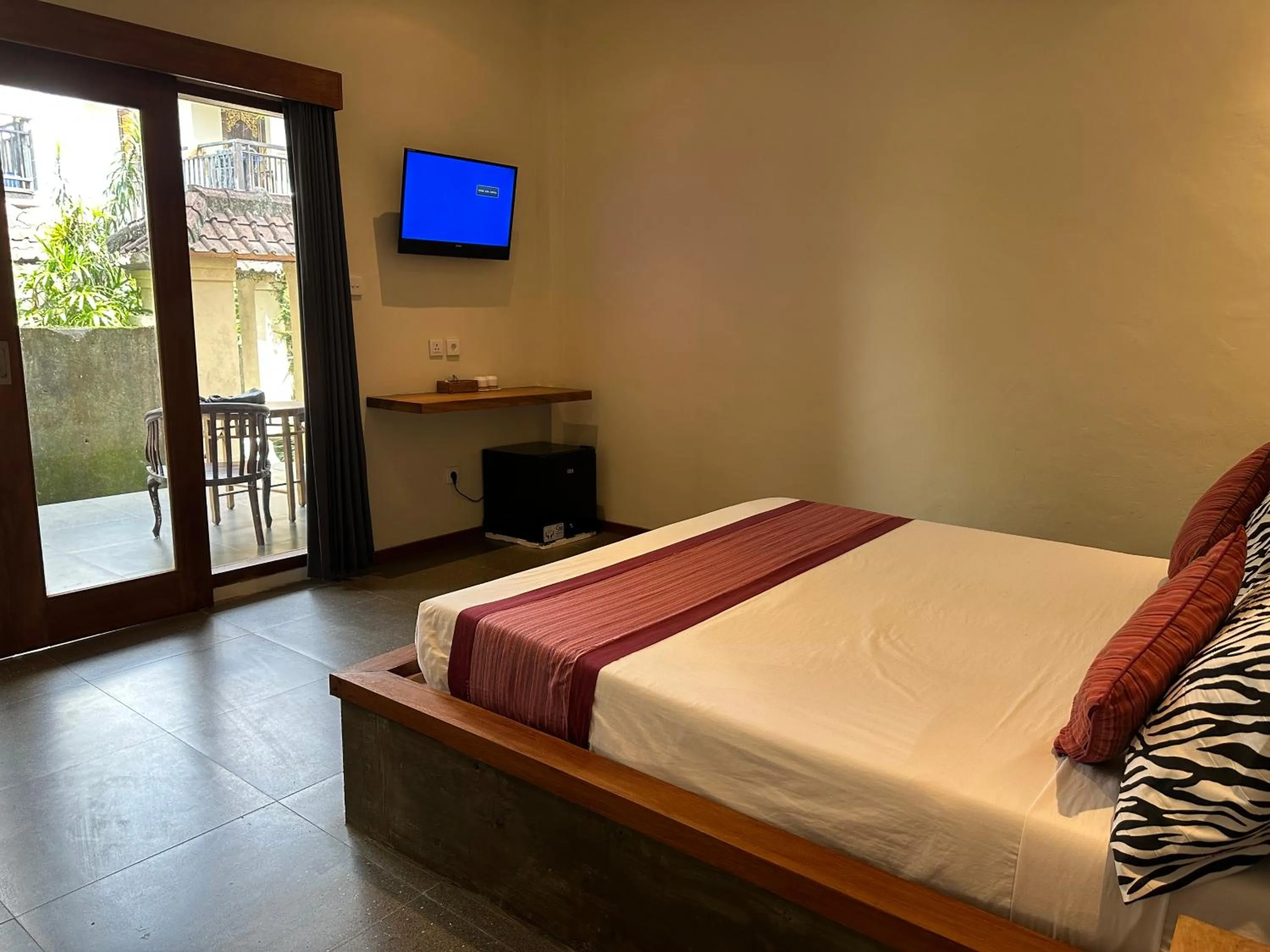 Communal lounge/ TV room, Bed in Warsa's Garden Bungalow and Spa