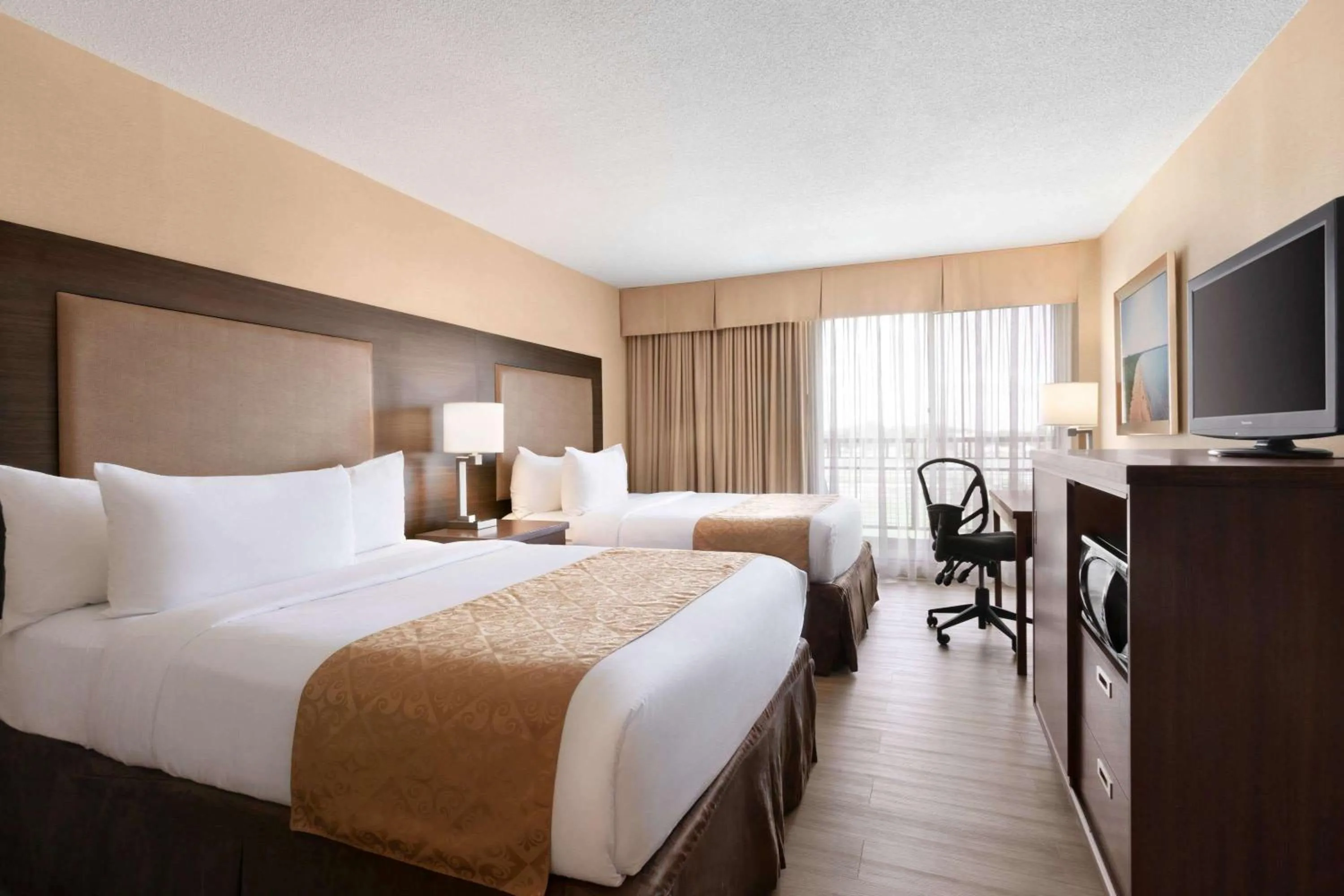 Bed in Ramada by Wyndham Belleville Harbourview Conference Center