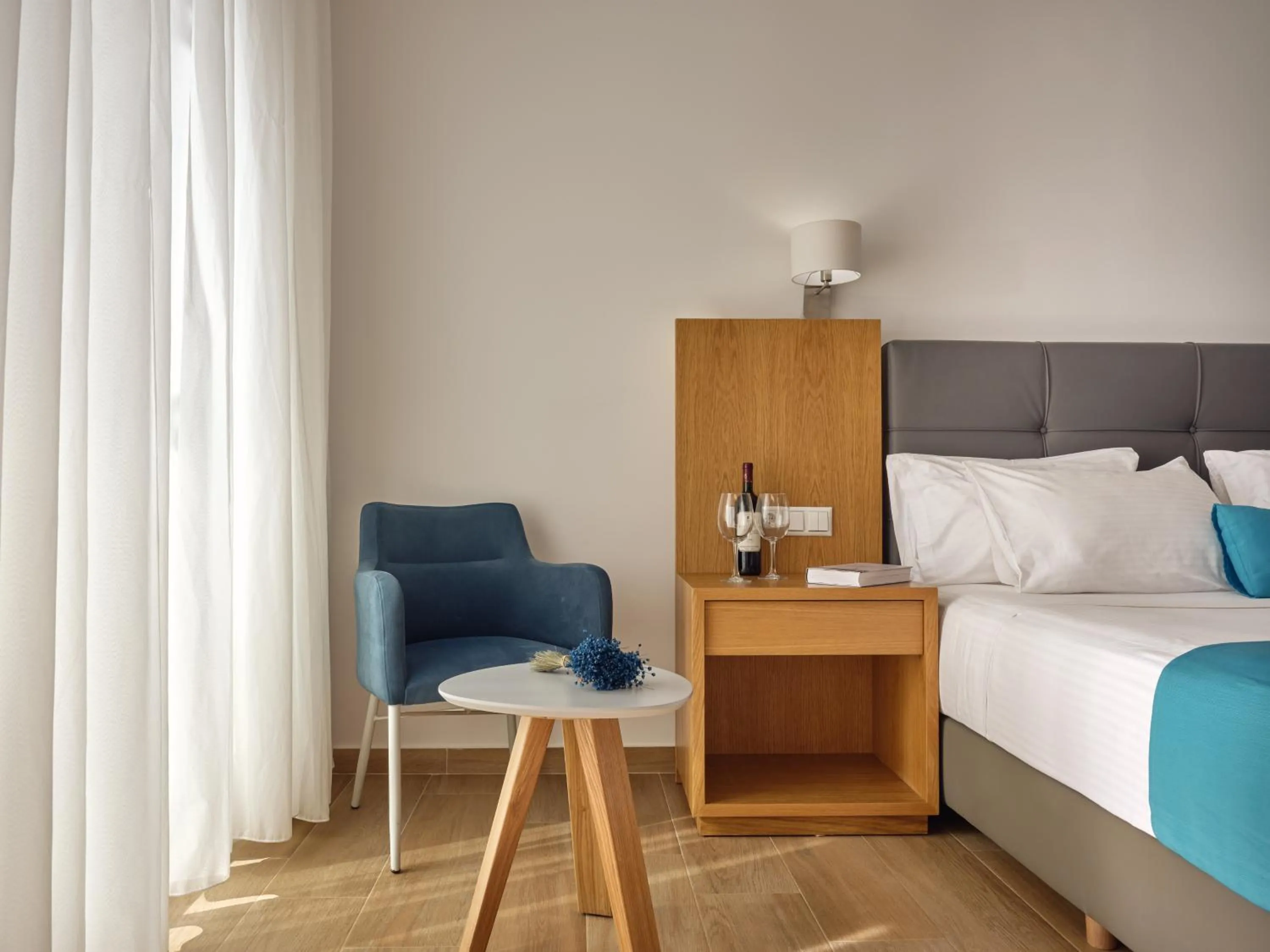 Seating area, Bed in Cavo Orient Beach Hotel & Suites