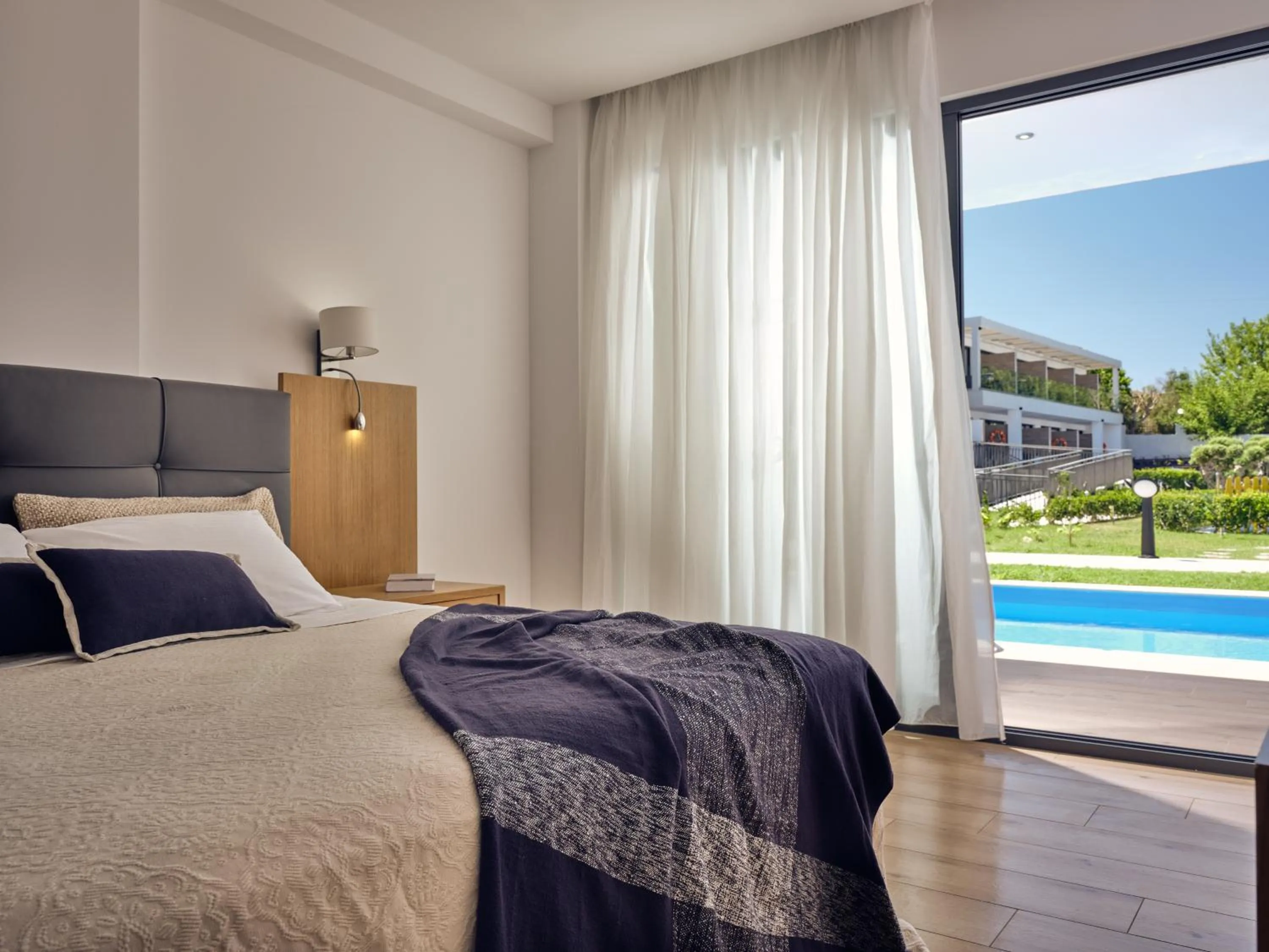 Bed in Cavo Orient Beach Hotel & Suites