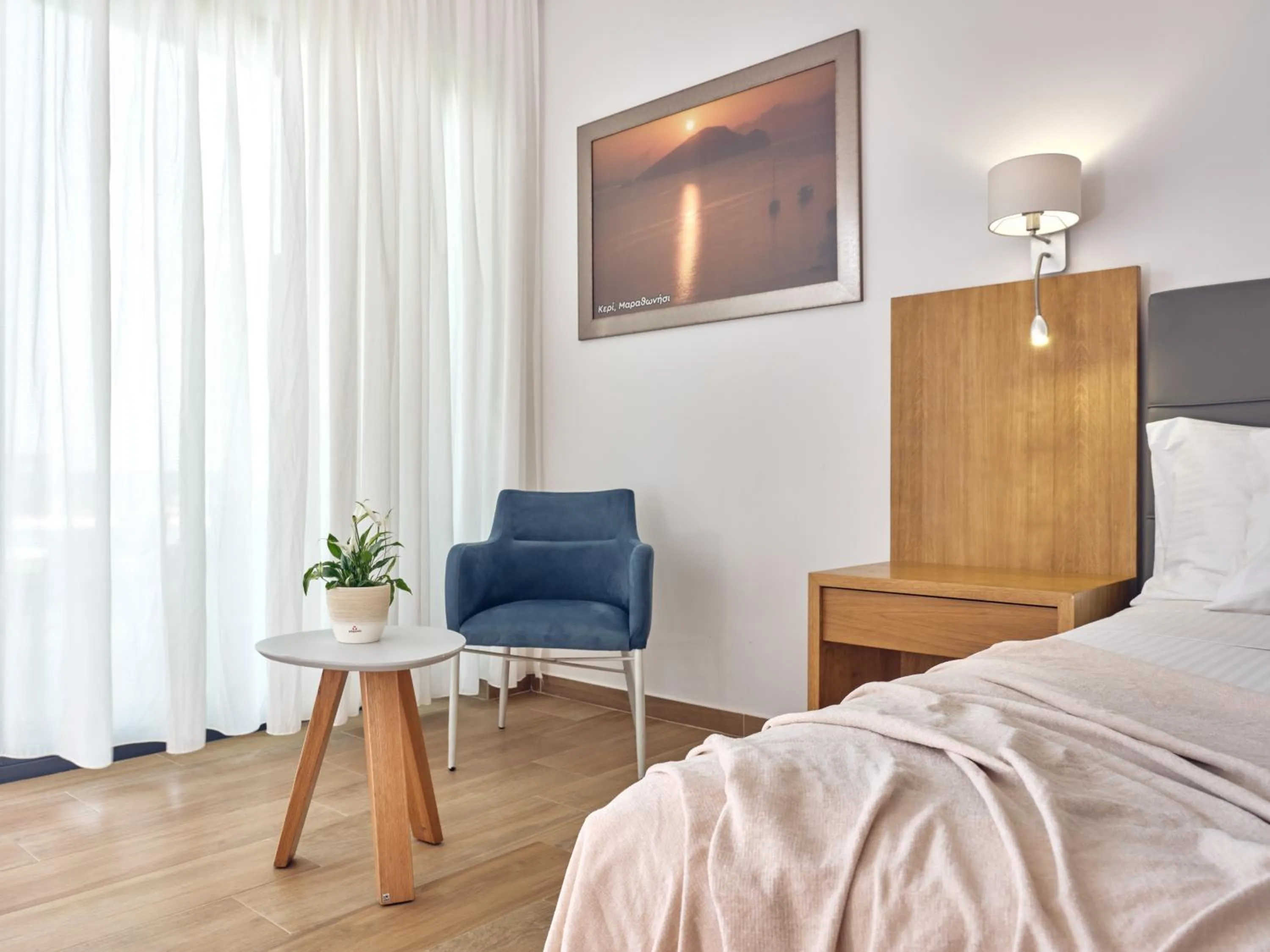 Seating area, Bed in Cavo Orient Beach Hotel & Suites