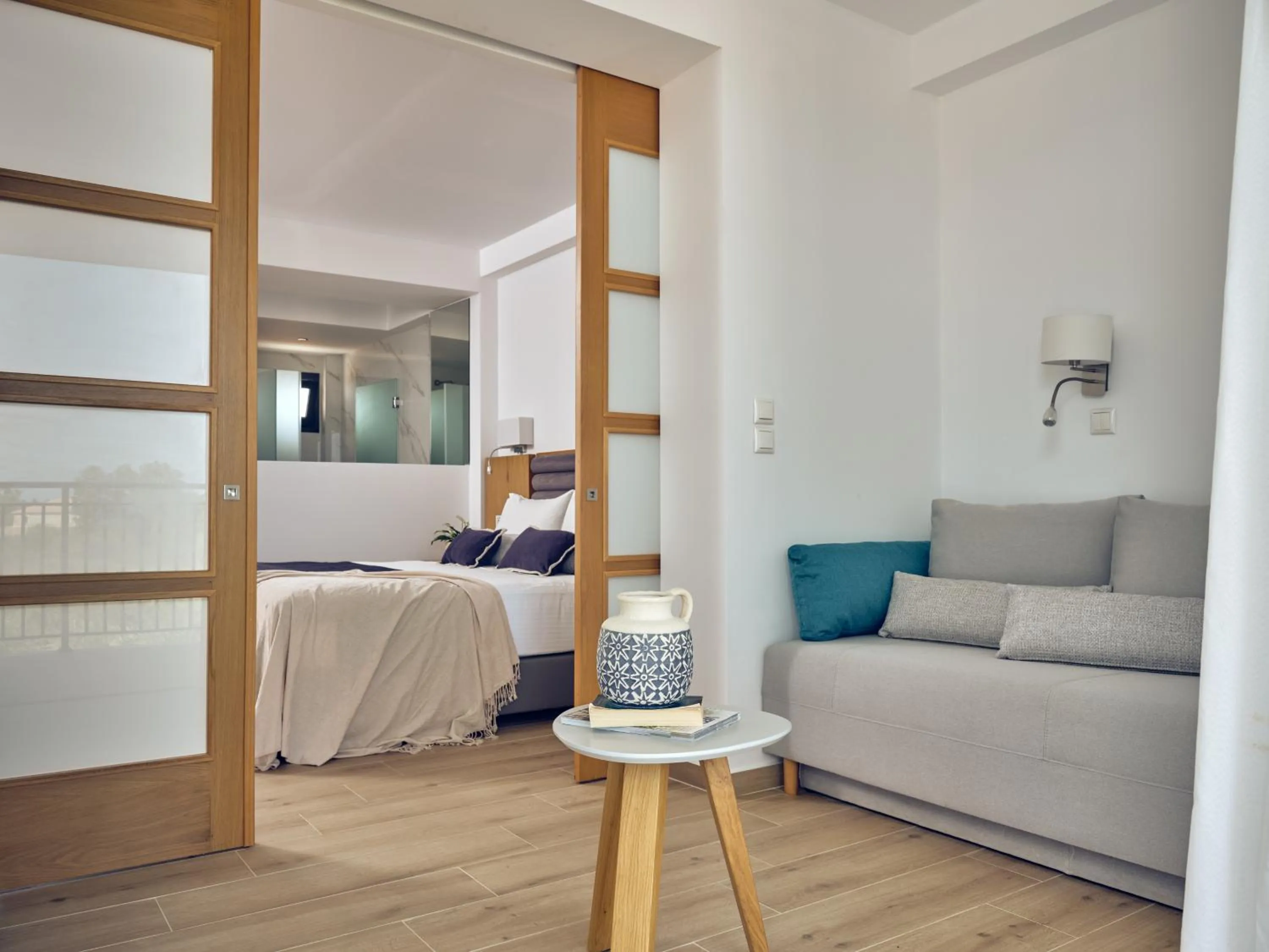 Seating area, Bed in Cavo Orient Beach Hotel & Suites