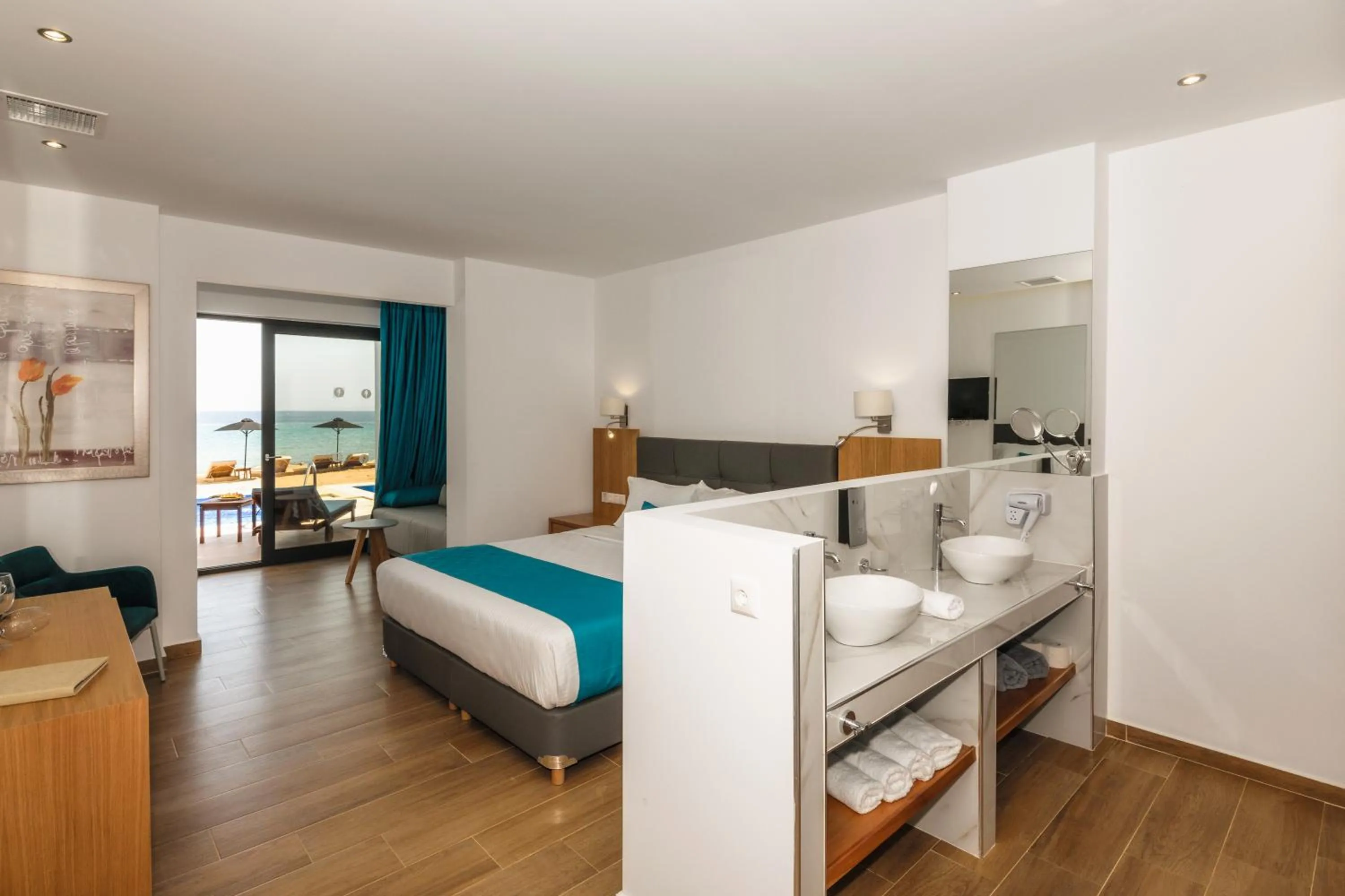 Photo of the whole room, Bed in Cavo Orient Beach Hotel & Suites