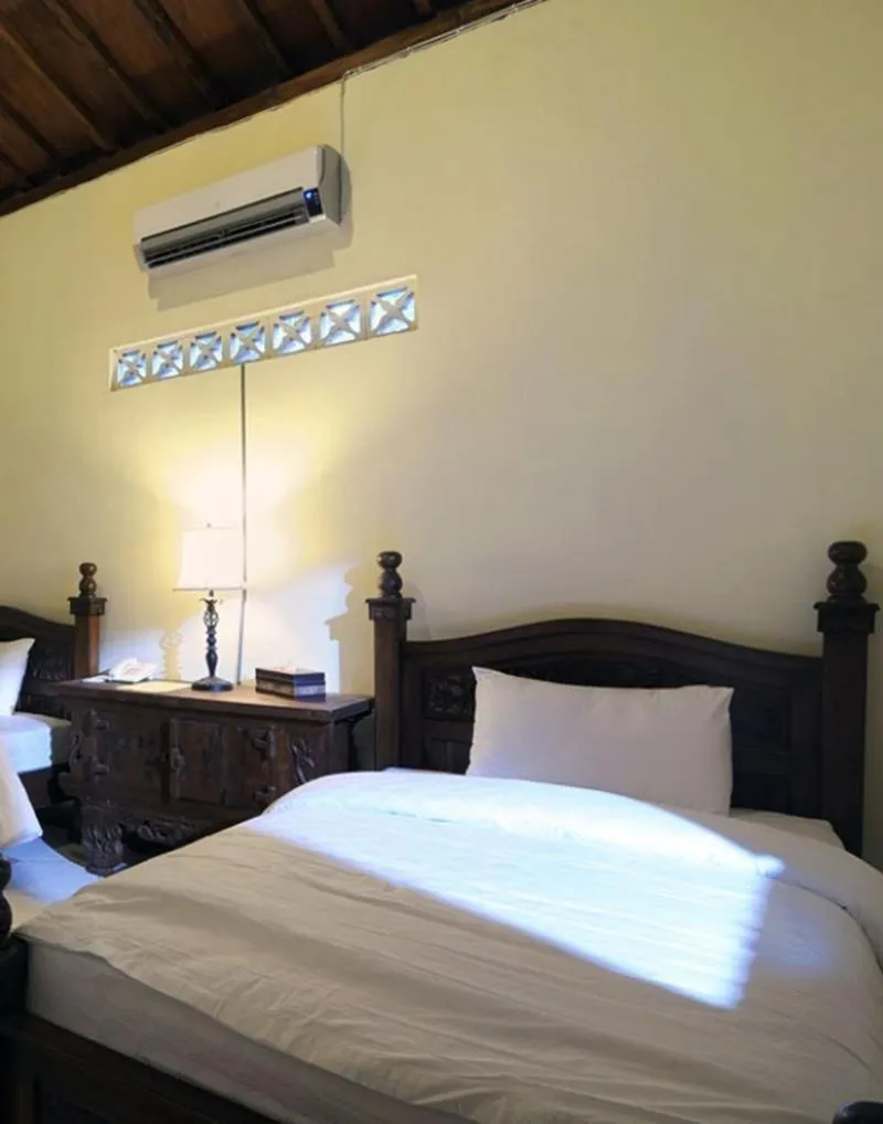Bed in Joglo Plawang Villa & Resort
