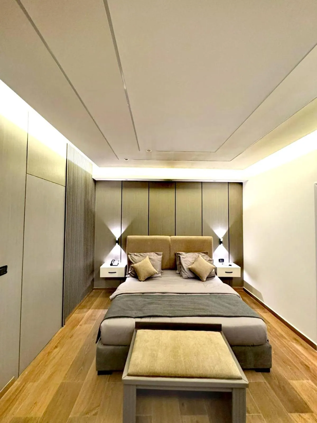 Bed in Queens Suite Hotel