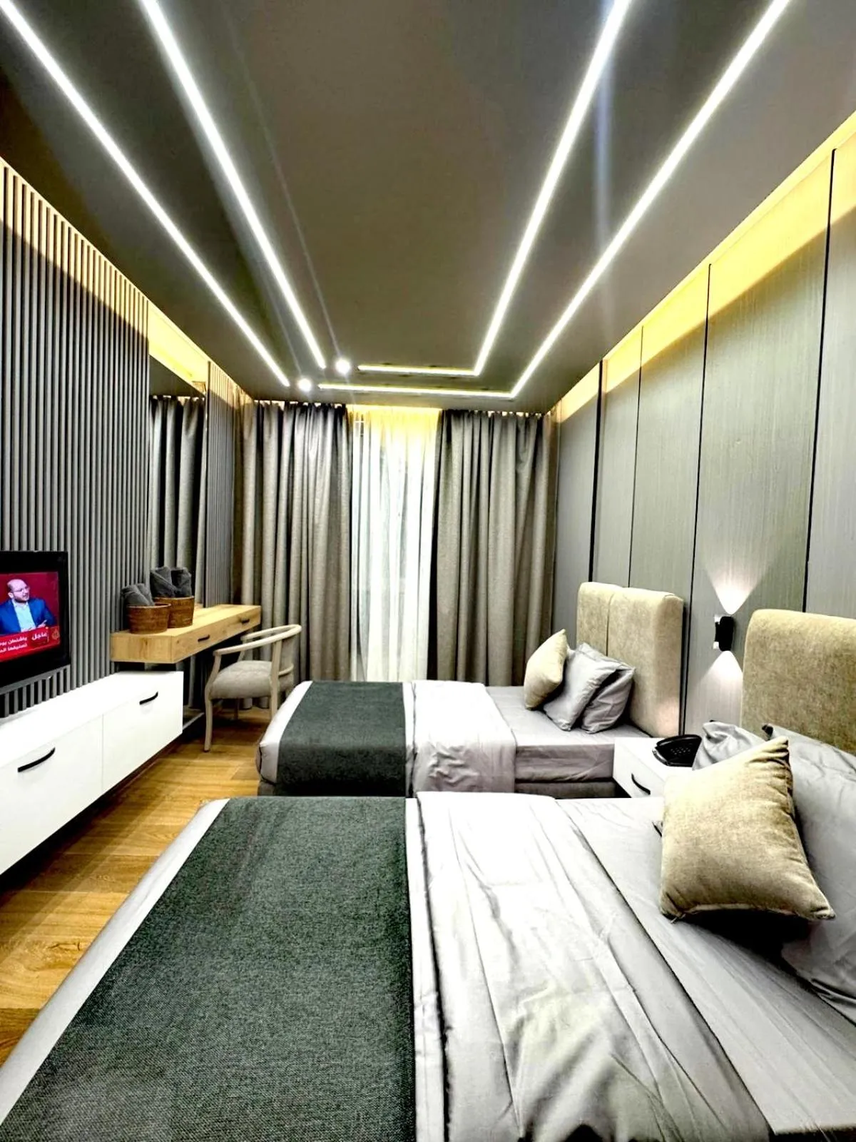 Bed in Queens Suite Hotel