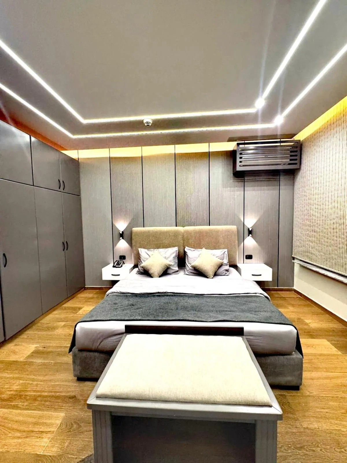 Bed in Queens Suite Hotel