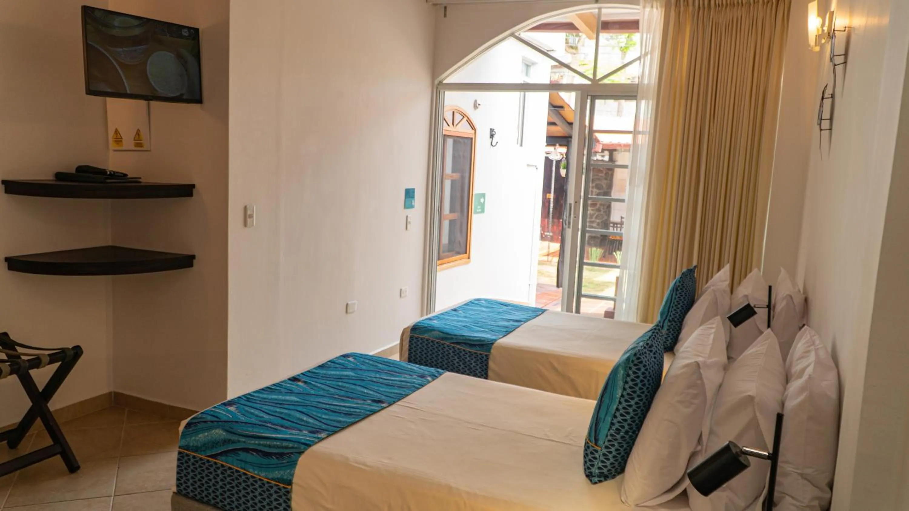 Bed in Hotel Galapagos Suites B&B