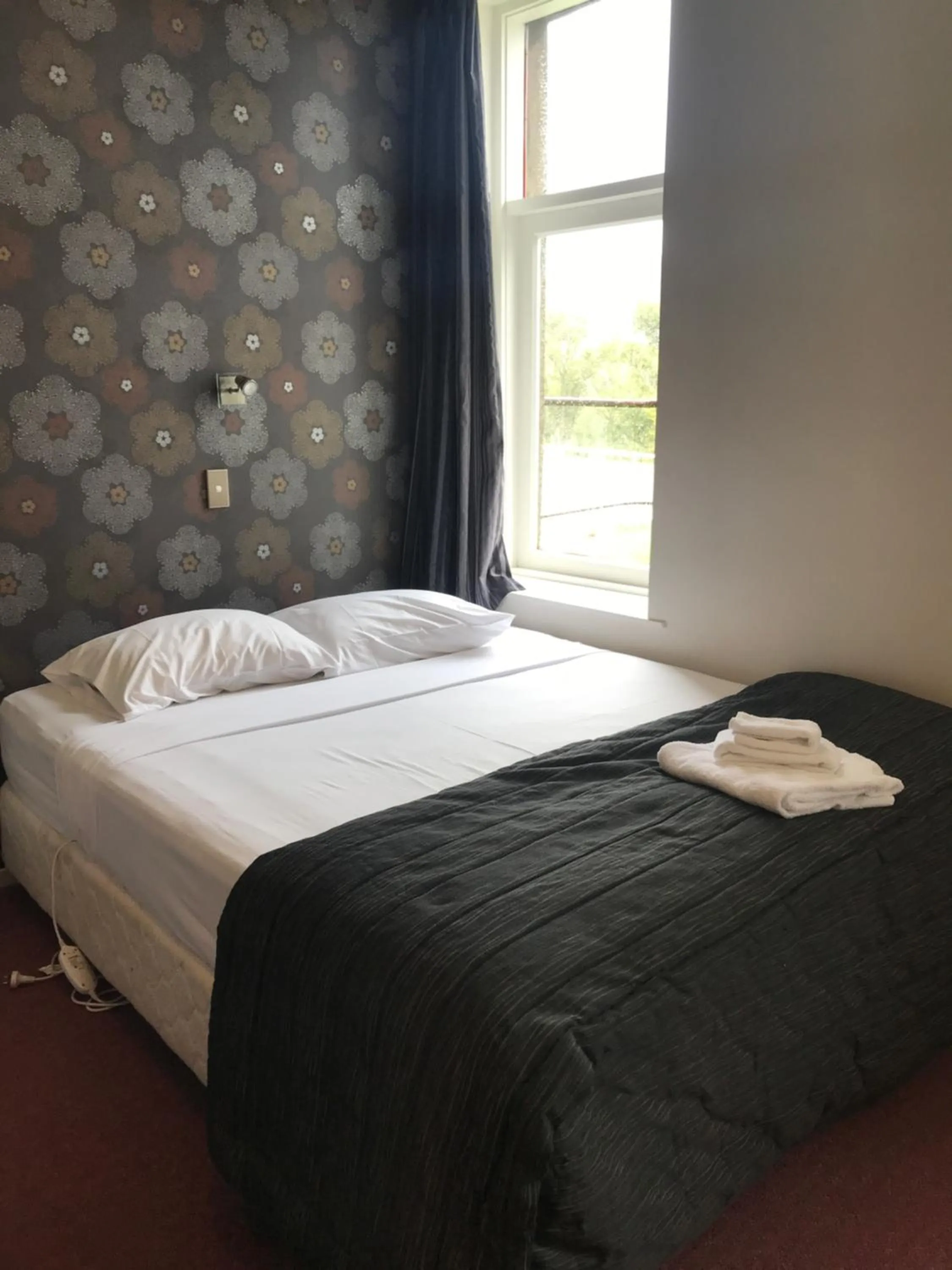 Bed in Criterion Club Hotel