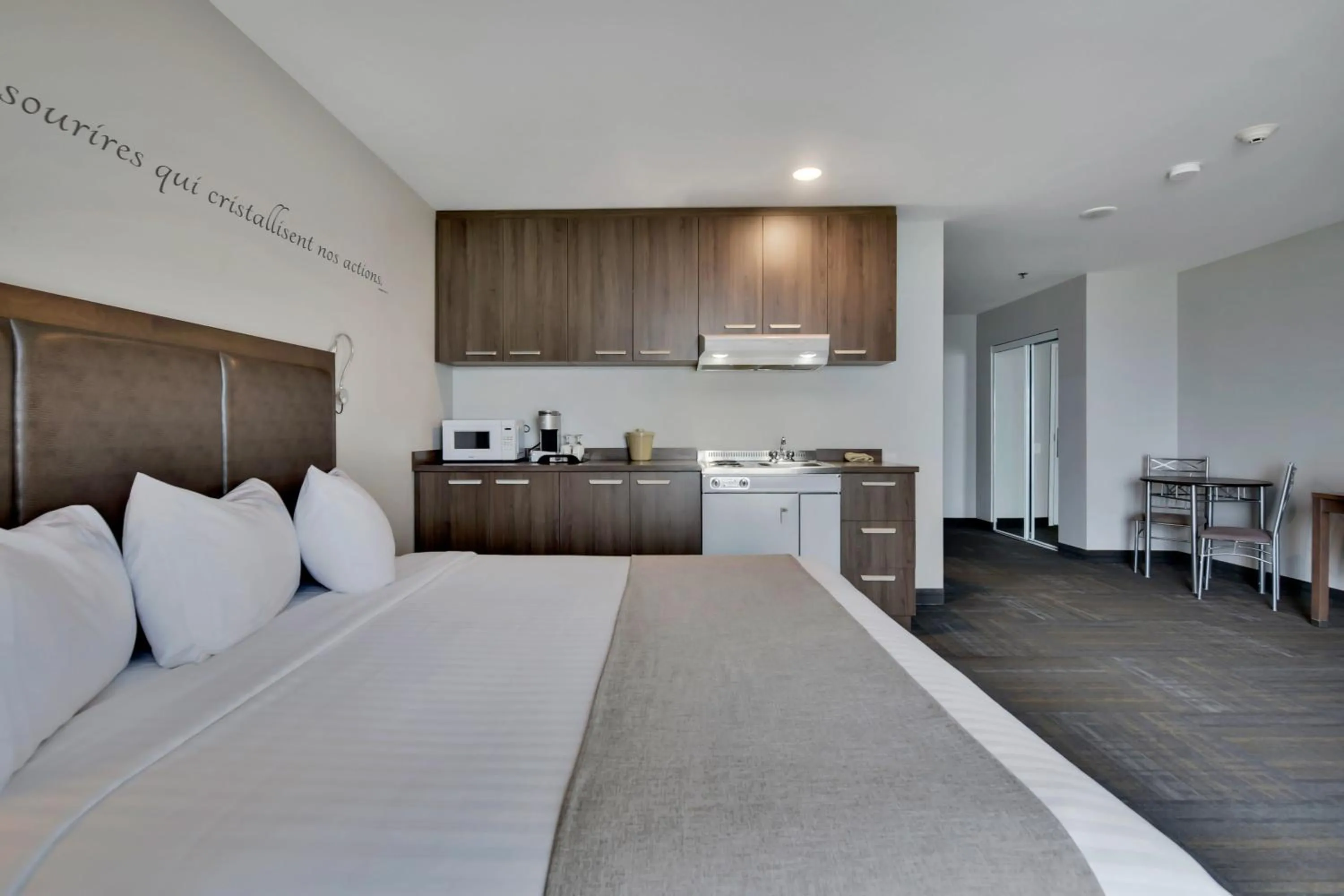 Kitchen or kitchenette, Bed in Hôtel et Pavillons Le Petit Manoir du Casino