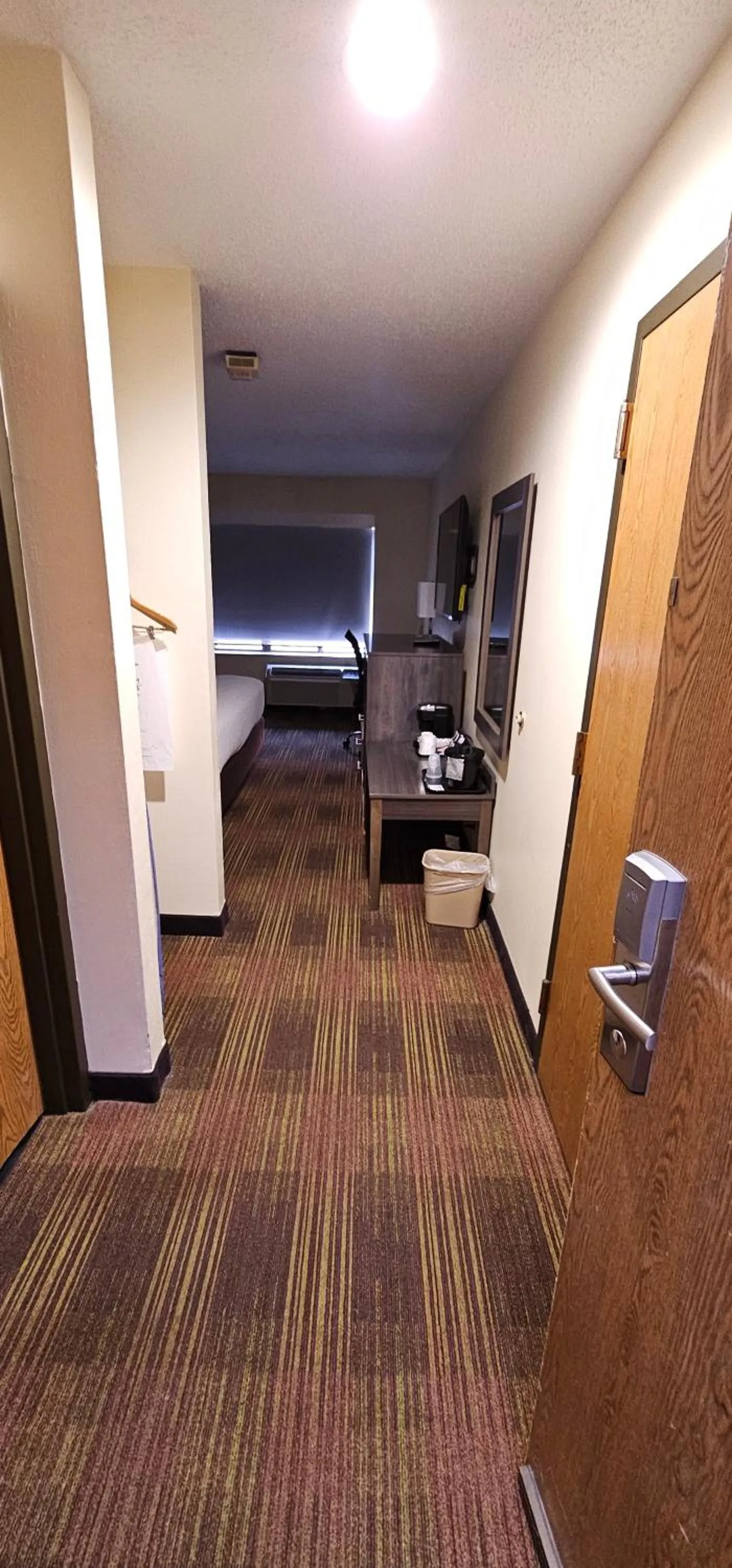 Text overlay, Bed in AmericInn by Wyndham Fort Atkinson