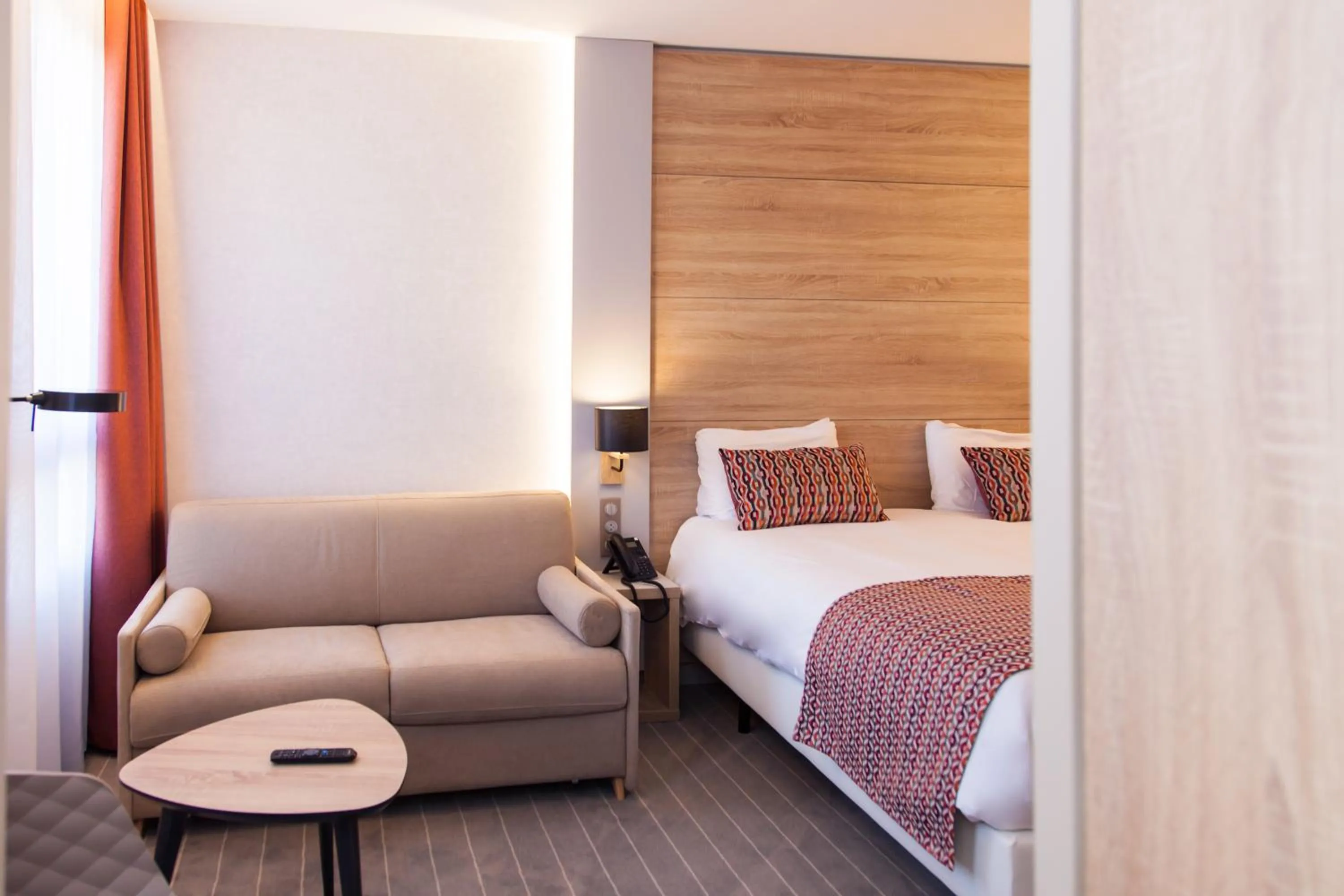 Seating area, Bed in Logis Hotel Relais Saint Jacques - Châteauroux