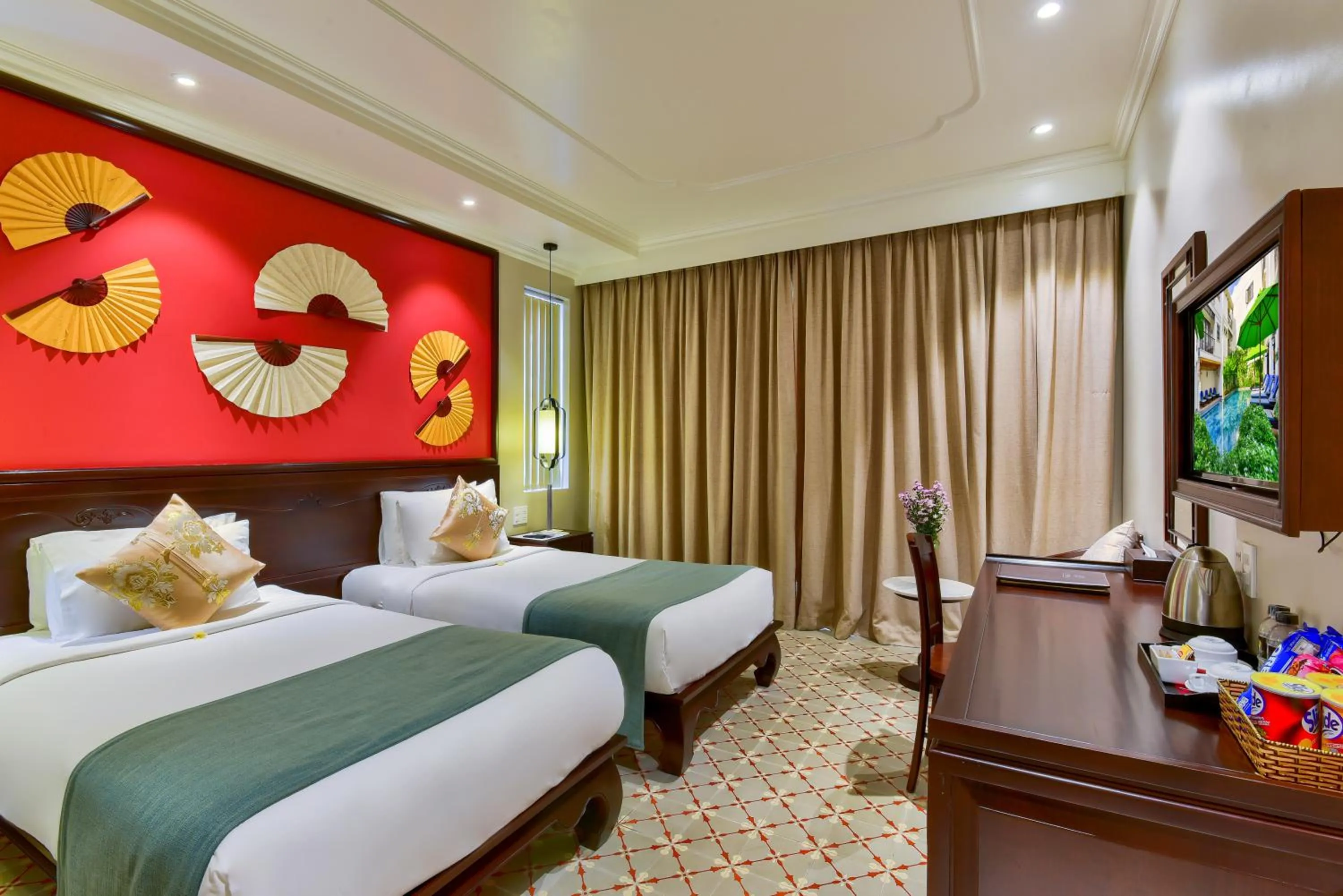 Communal lounge/ TV room, Bed in Laluna Hoi An Riverside Hotel & Spa