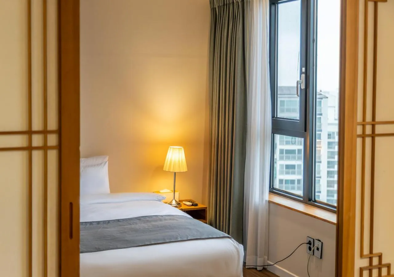 Bed in JK Blossom Hotel